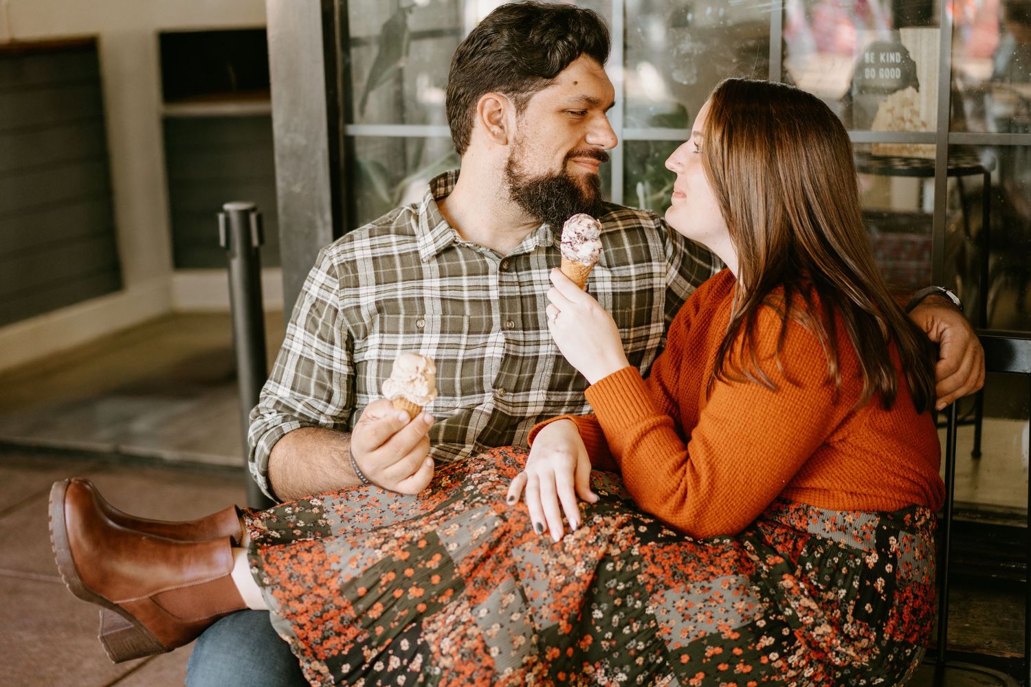 A couple shares a romantic moment together in a cozy indoor setting with warm lighting.
