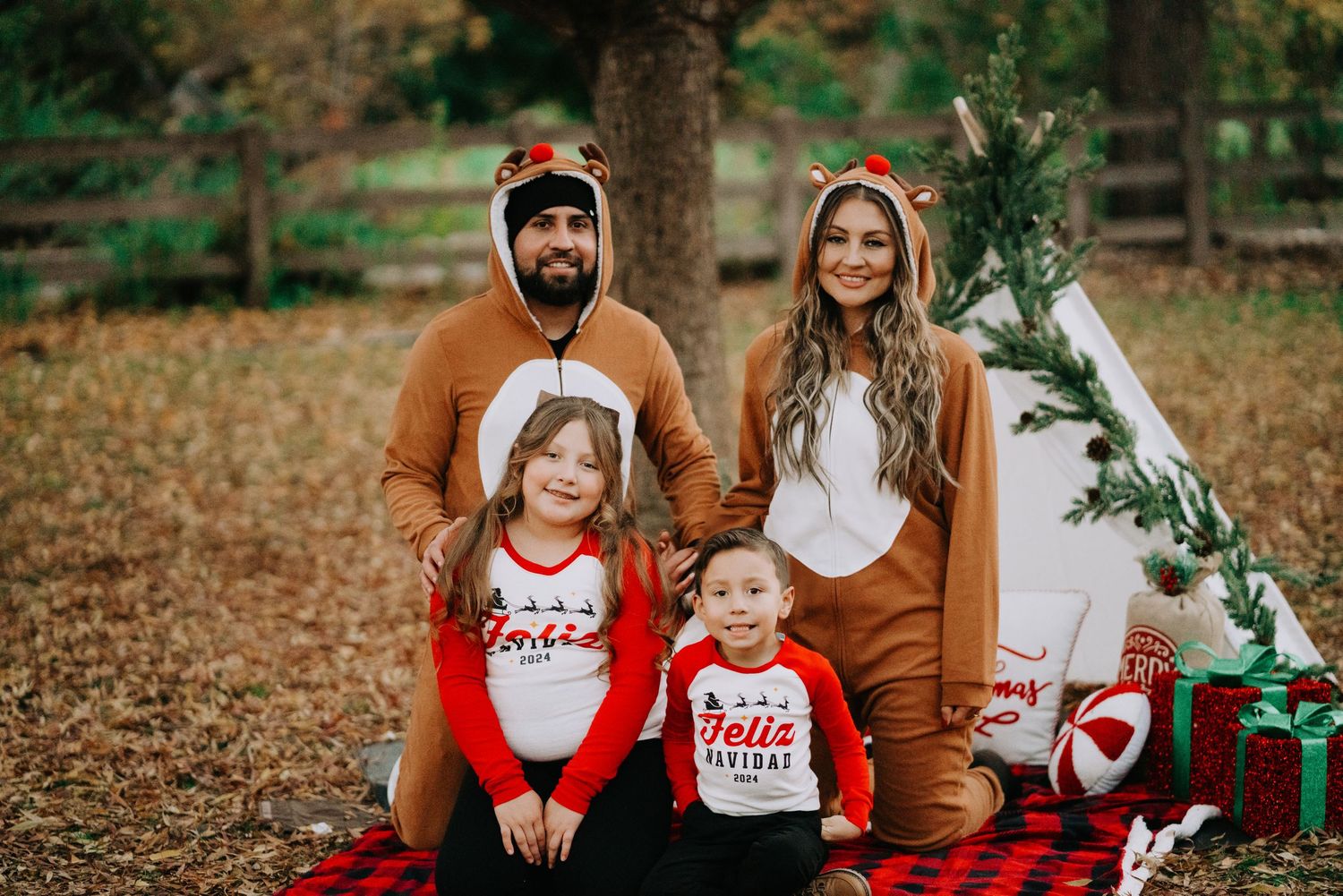 Holiday-themed family photos being taken outdoors with festive matching outfits.