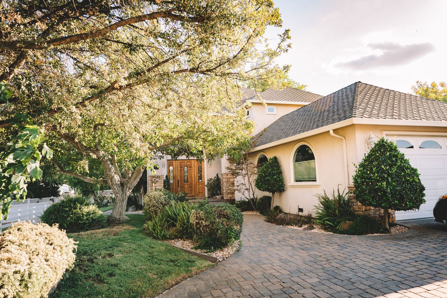 Residential homes with well-maintained yards and driveways viewed from above at La Grande Estates