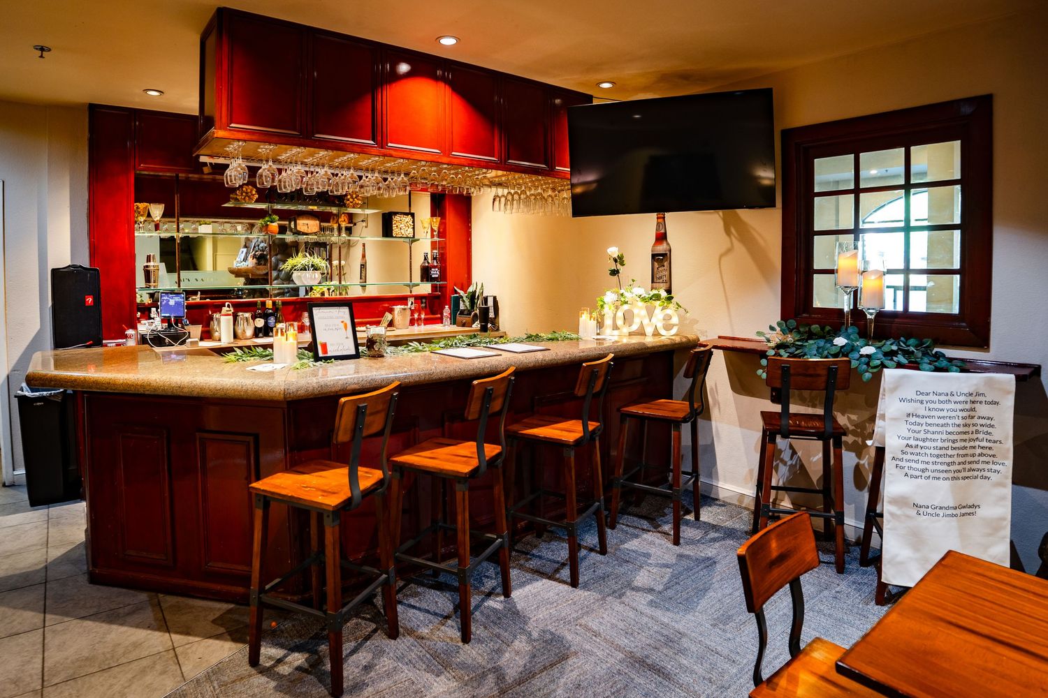 Cozy bar area with dark wood finishes, red accent walls, and ambient lighting creating an intimate atmosphere at Forest Suits Resorts