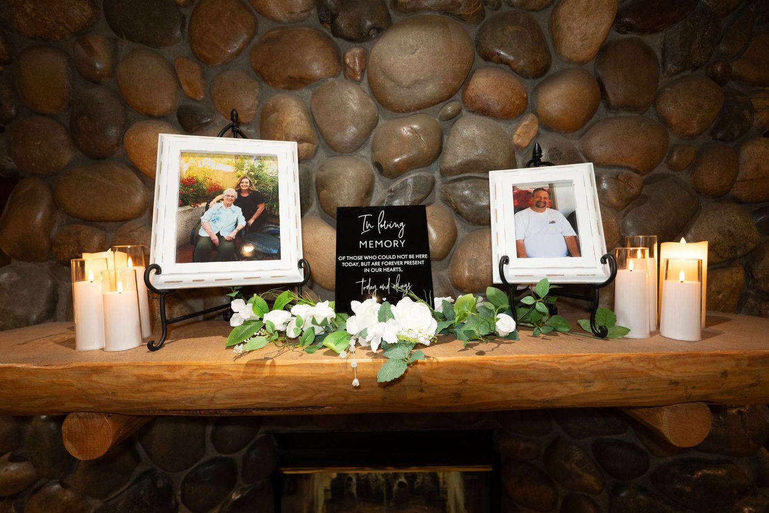 Rustic stone mantel decorated with candles, flowers and framed photographs for an event at Forest Suits Resorts