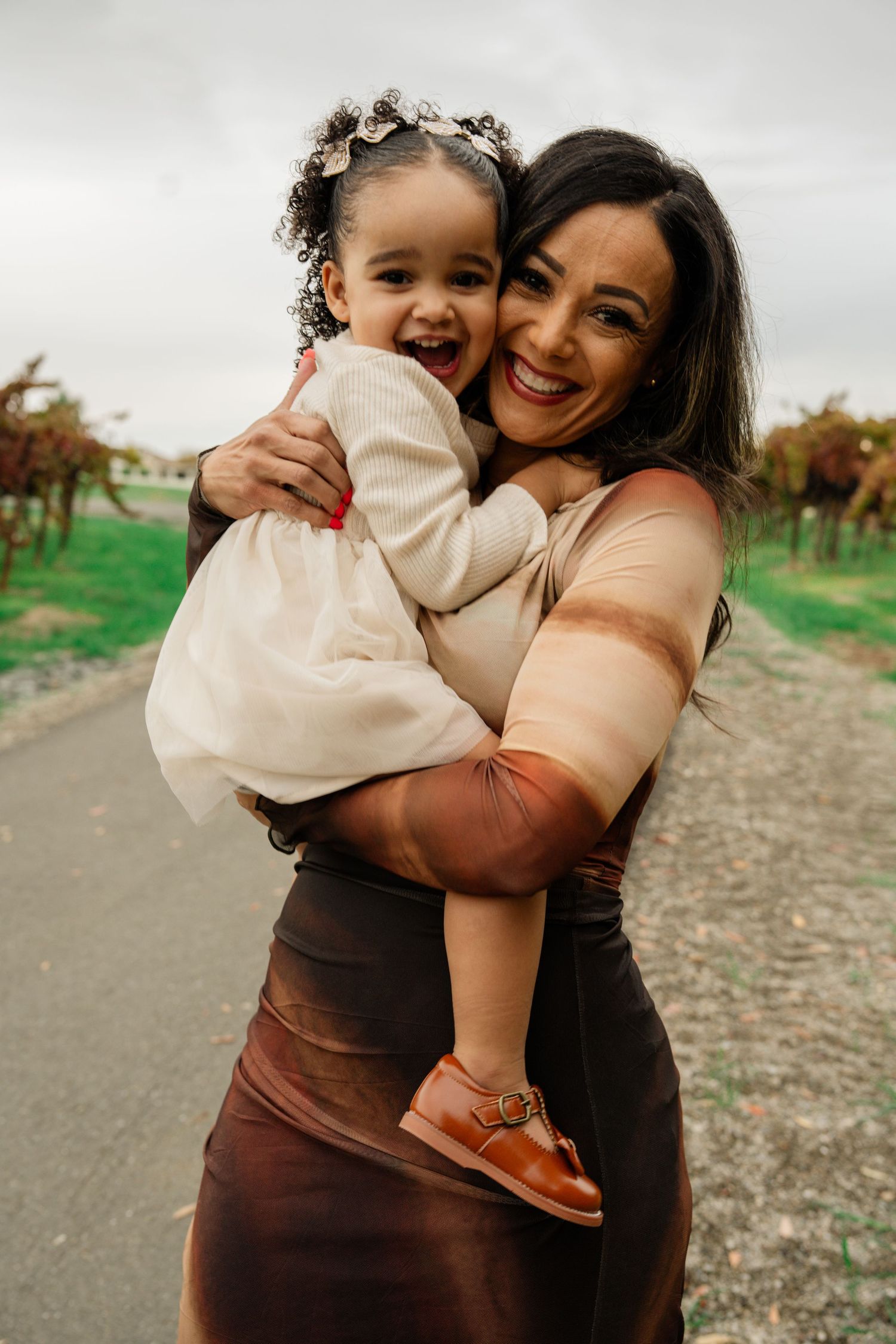 Candid moments of affection captured during an outdoor family photoshoot.