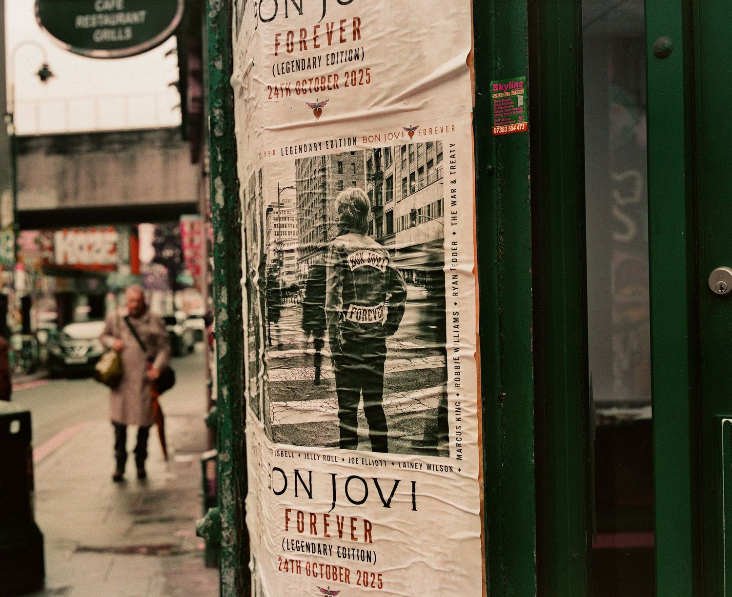 Bon Jovi Forever Legendary Edition concert tour posters displayed on a busy urban street wall.