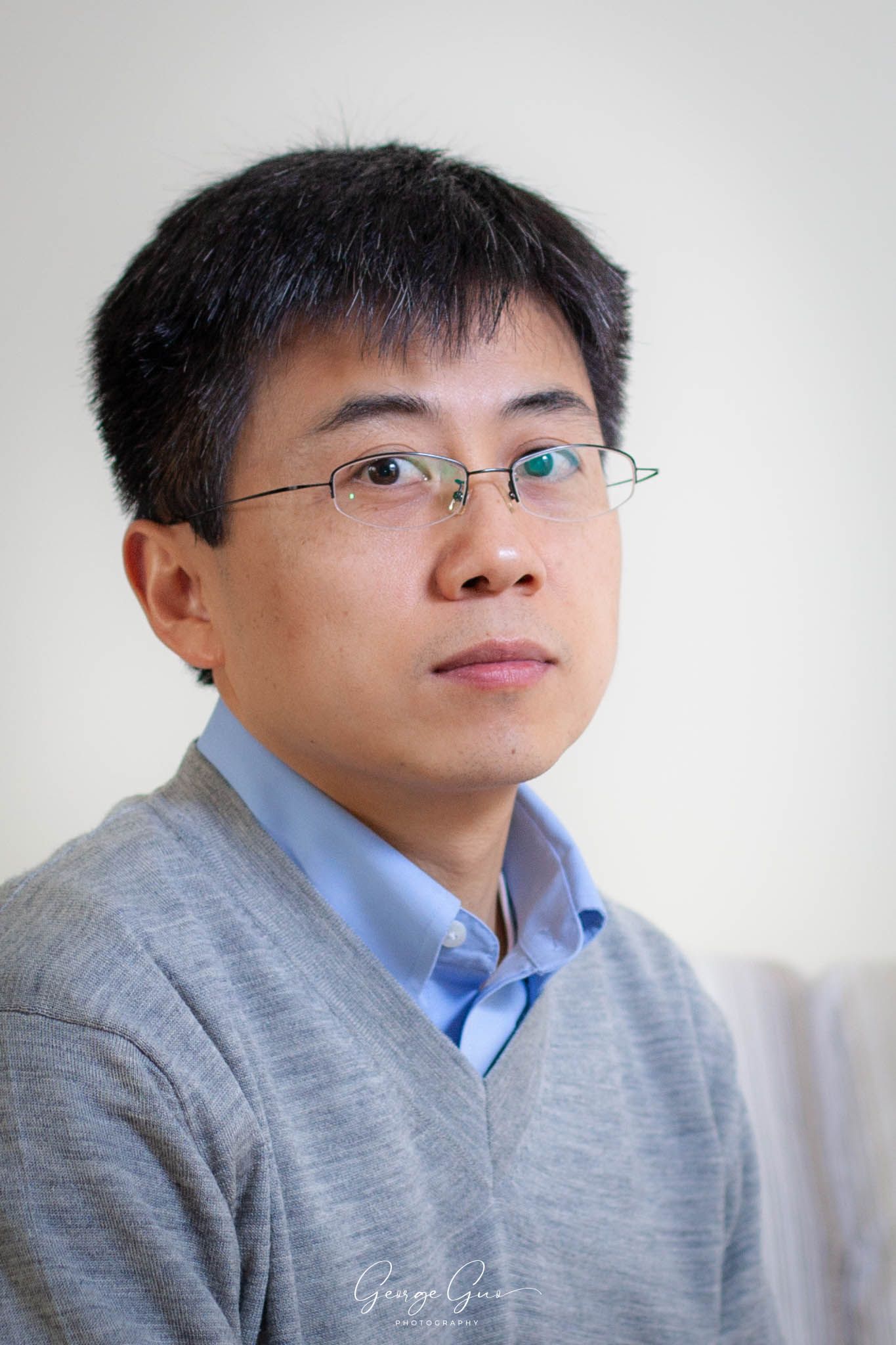 George Guo Photographer professional self headshot portrait with neutral background