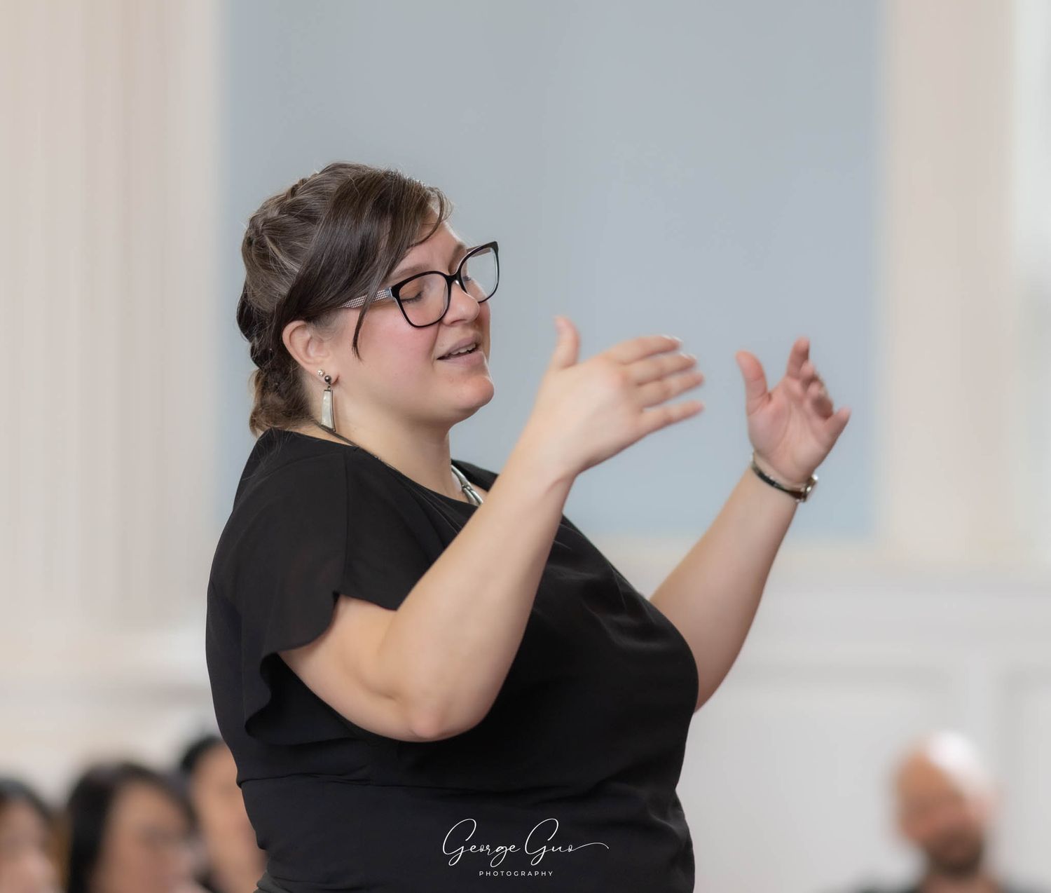 A music director performing and fully immersed on stage during a church concert, photographed by George Guo Photographer