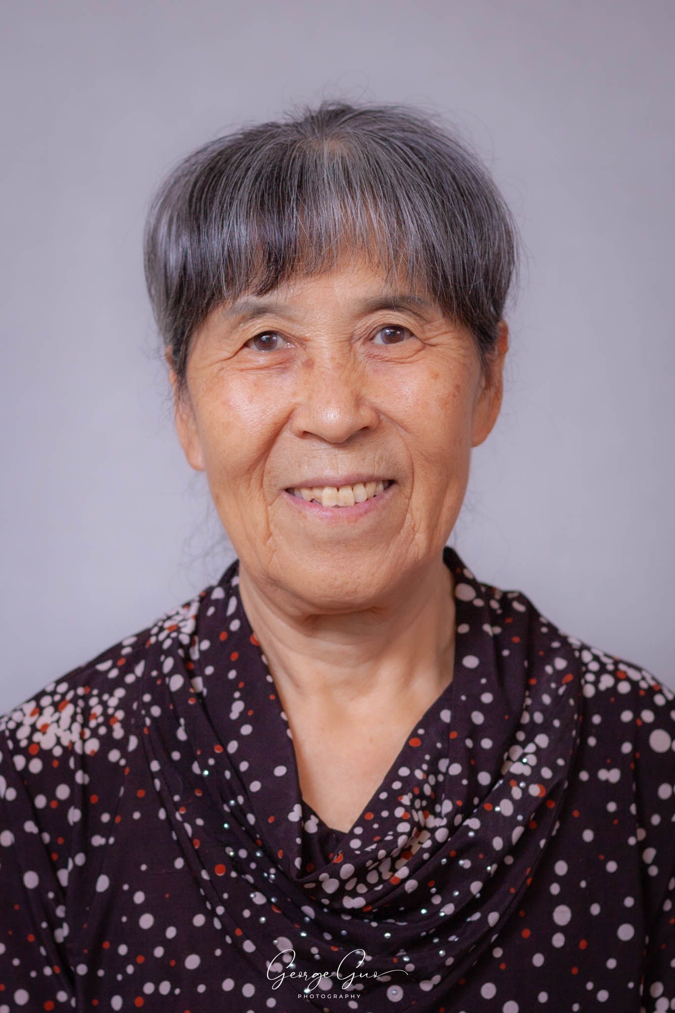 Professional headshot of a woman wearing a dress, captured in a studio lighting setup by George Guo Photographer