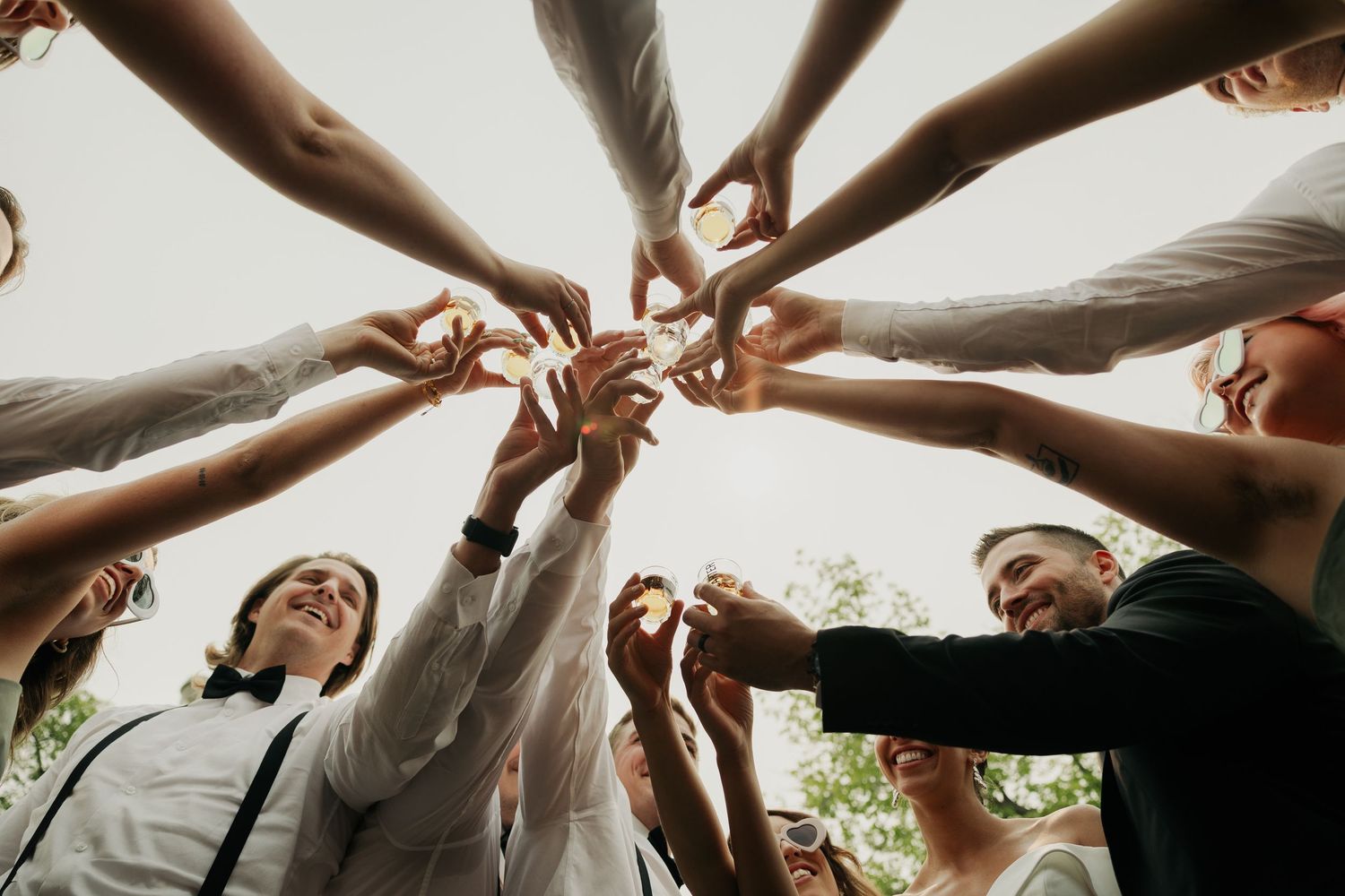Alberta wedding photography capturing wedding party toast and group celebration moment.