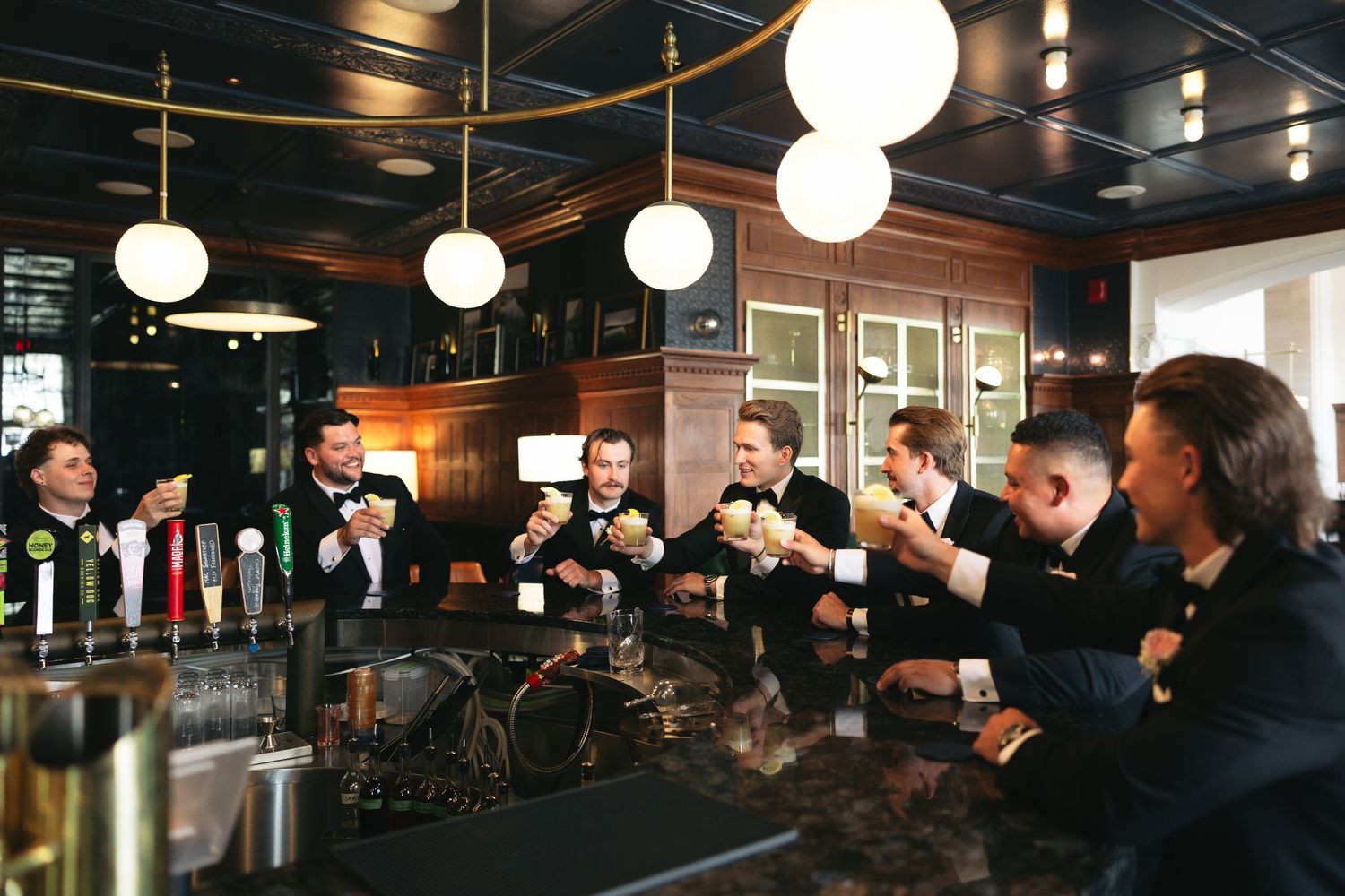 groomsmen and groom drinking together