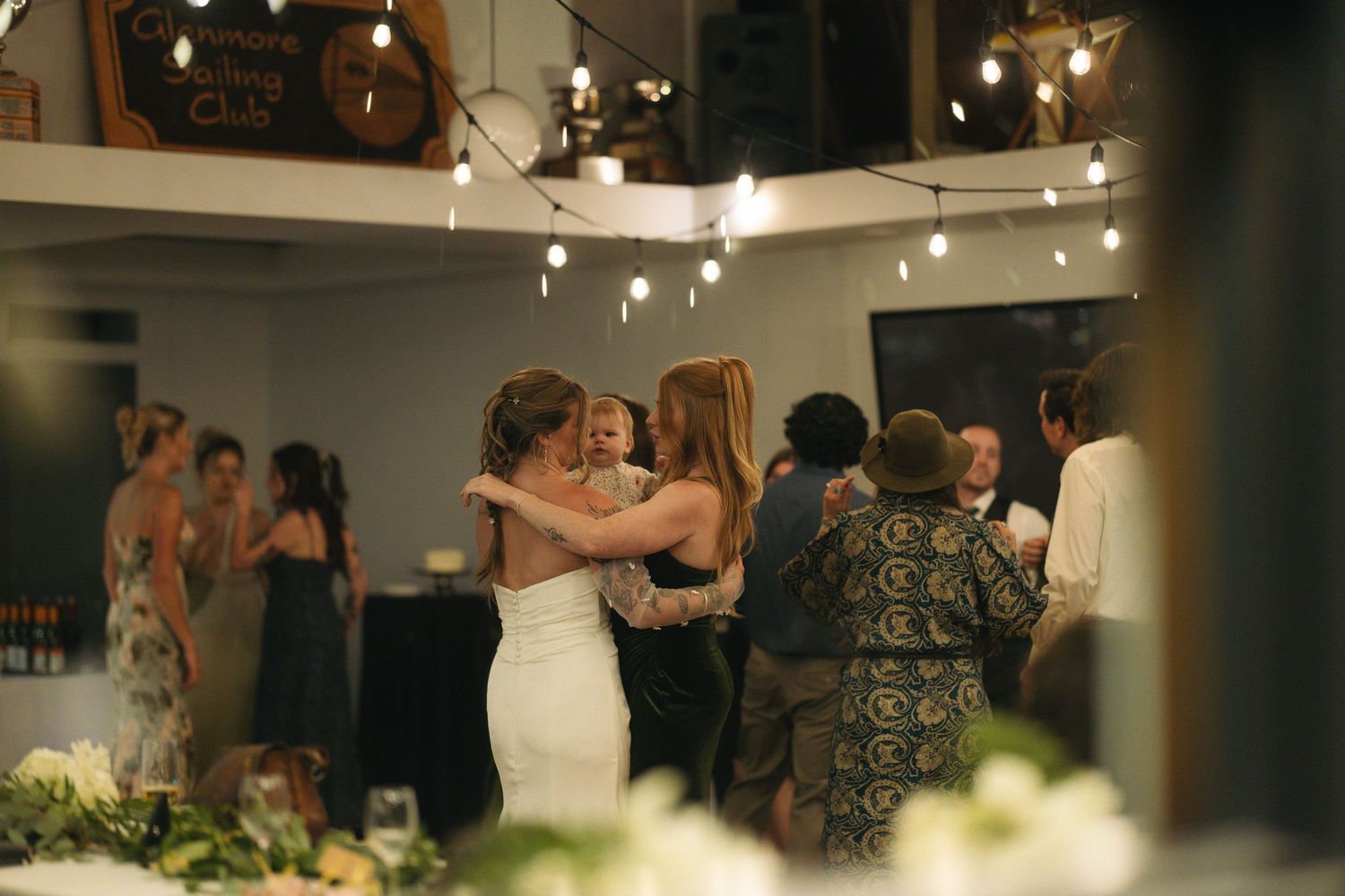 wedding reception capturing friends hugging during dancing