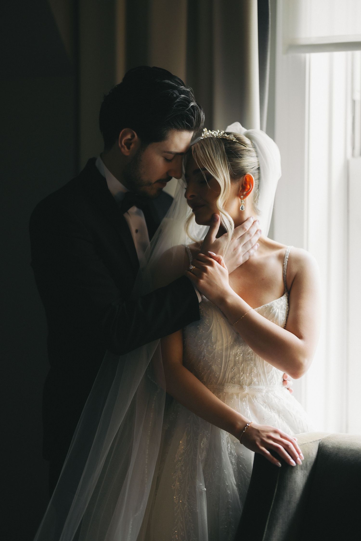 Bride and groom portrait by window with natural light Edmonton wedding photographer