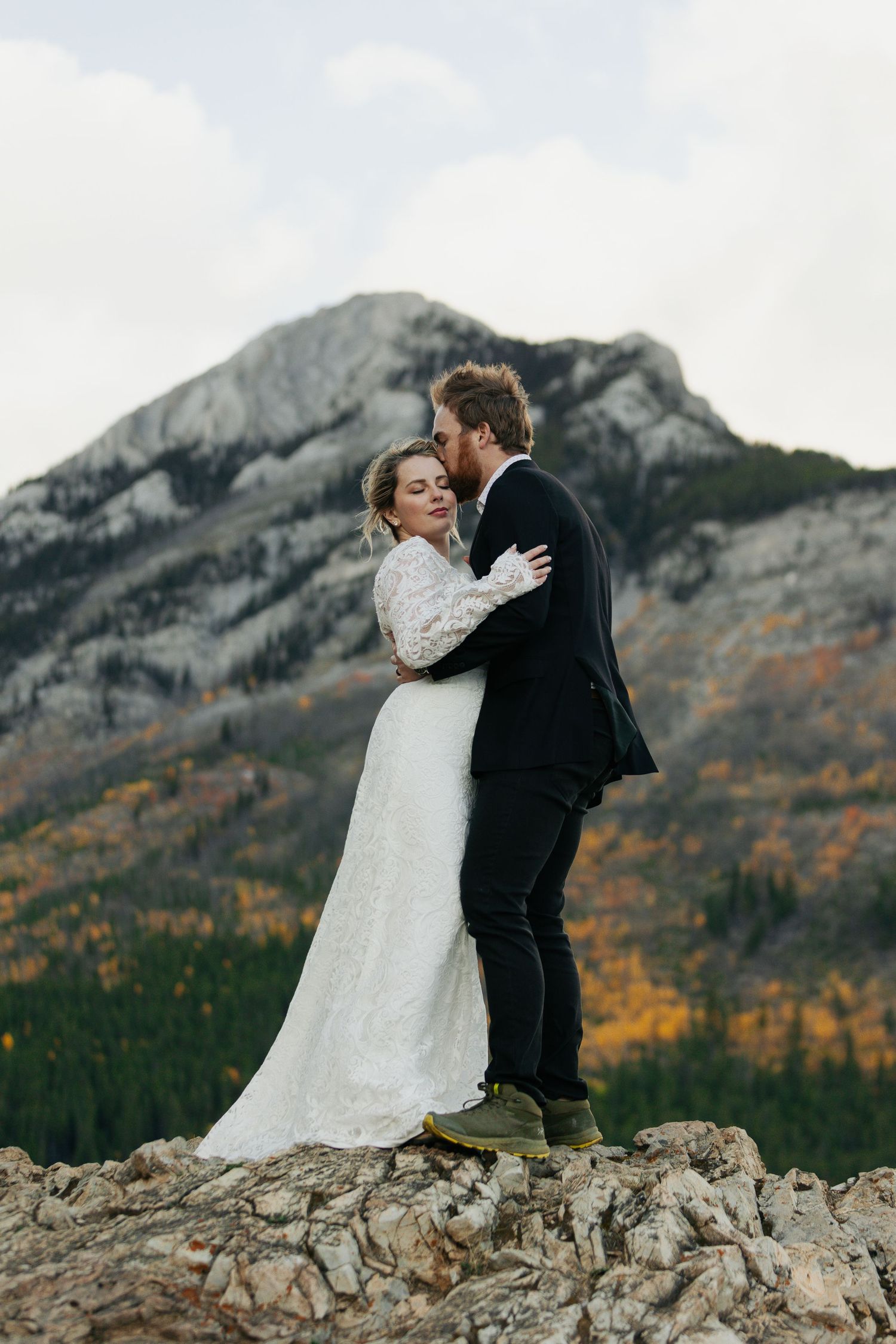 Banff wedding photography capturing candid moment of couple kissing