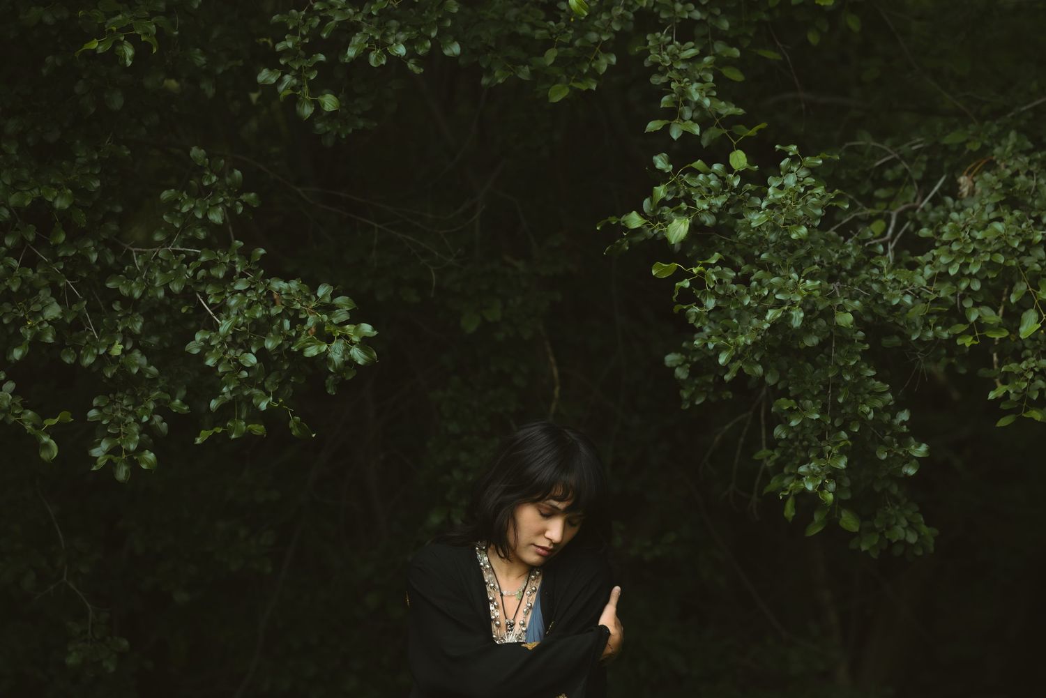 women embracing herself in forest