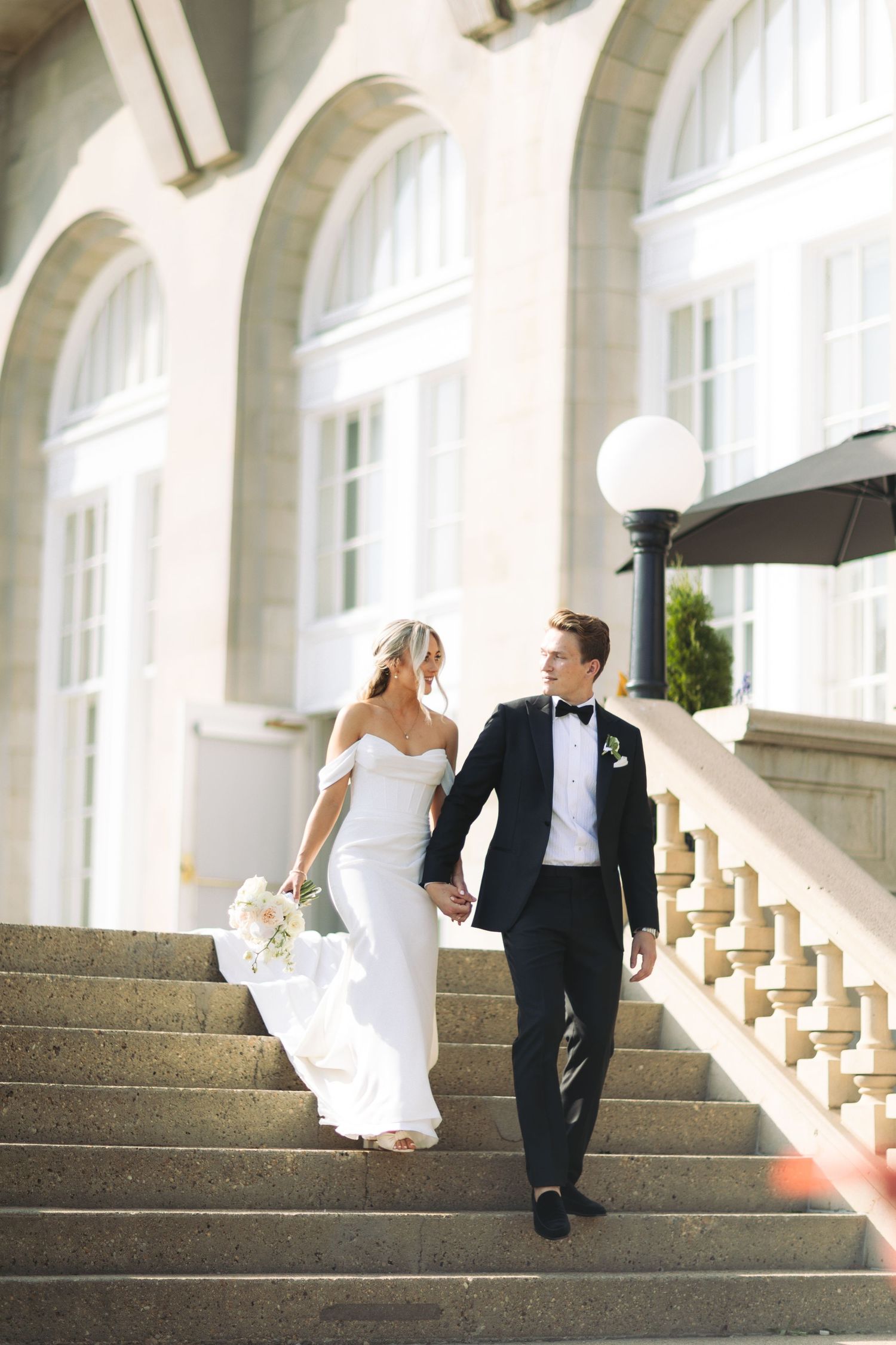 fairmont wedding couple walking down the stairs in Edmonton