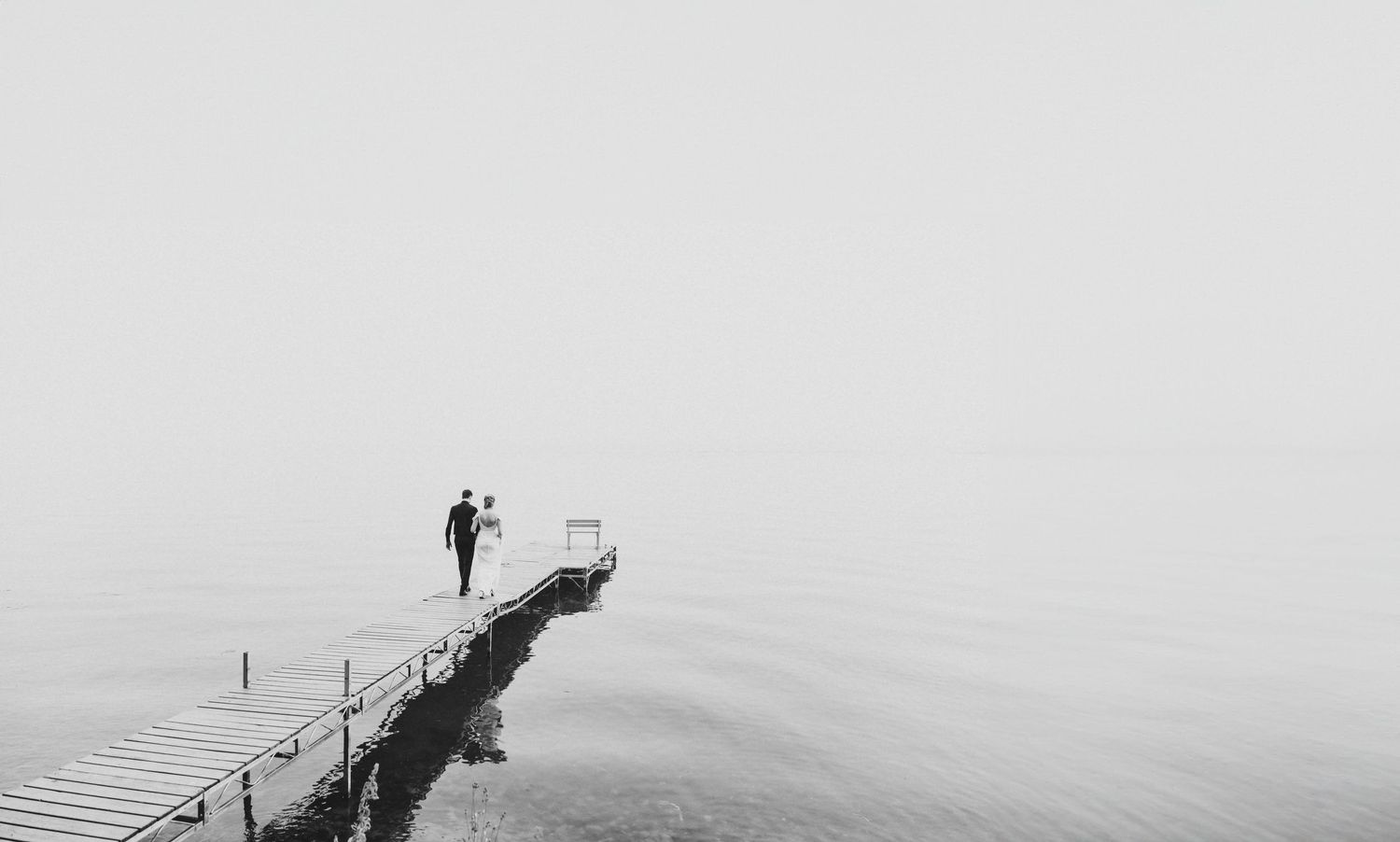 Couple walking dock on wedding day, photographed by alberta wedding photographer