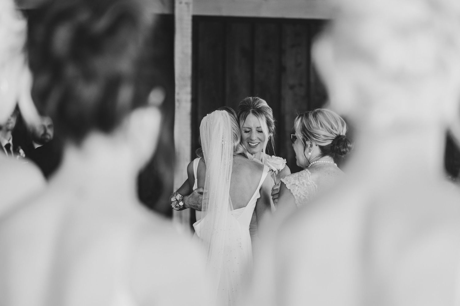 mom hugging bride before getting married