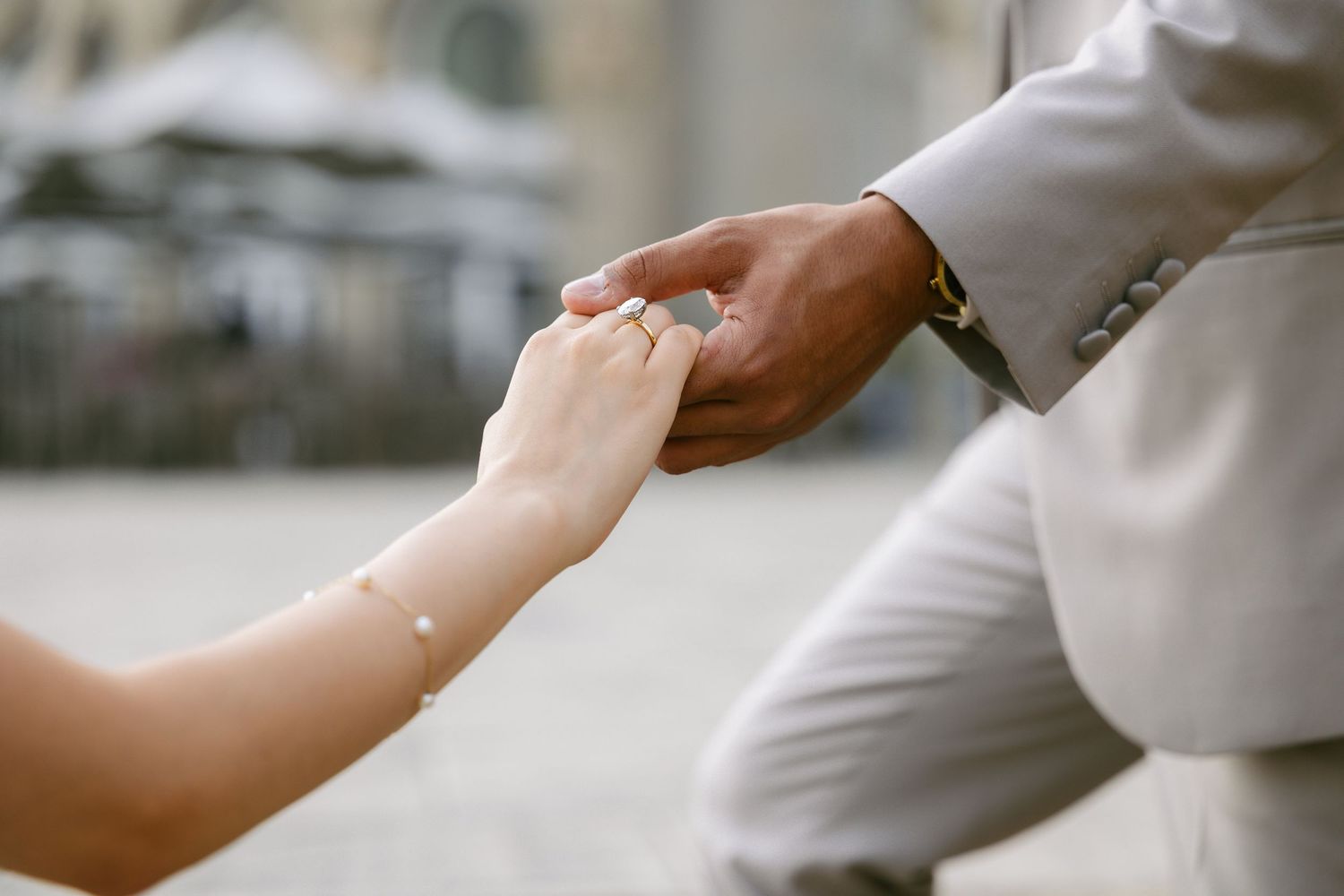 photo of hands showcasing engagement ring