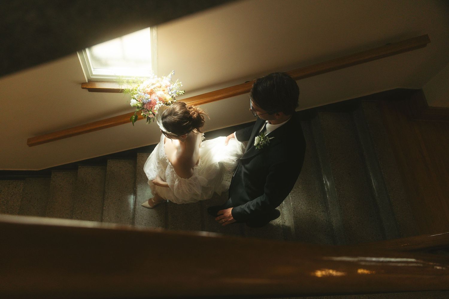 couple walking down the stairs during wedding day