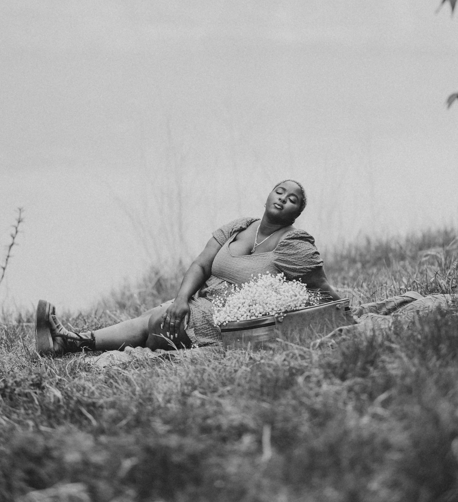 model having picnic by the river in black and white