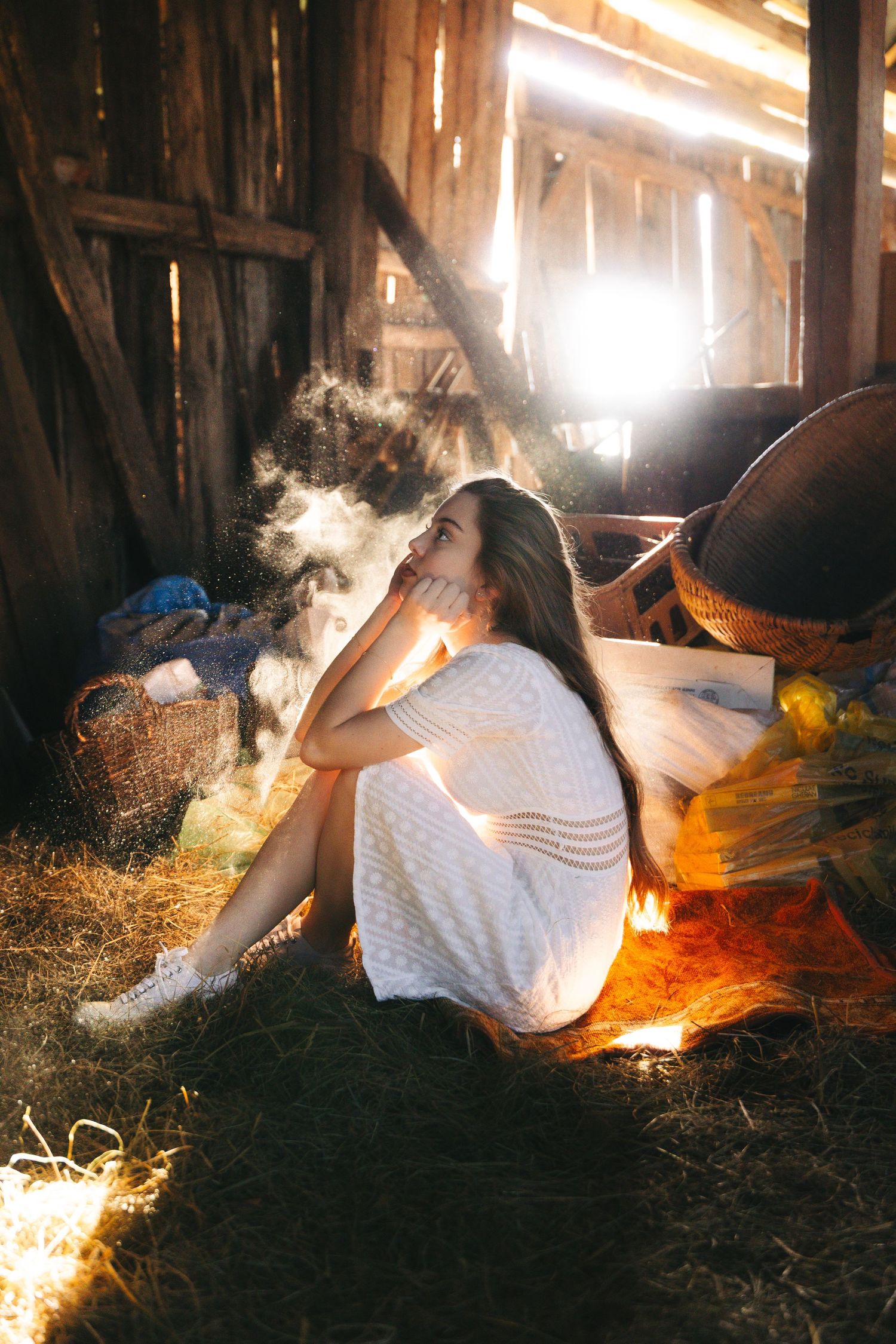 romanian barn photoshoot with light coming through barn and woman modelling