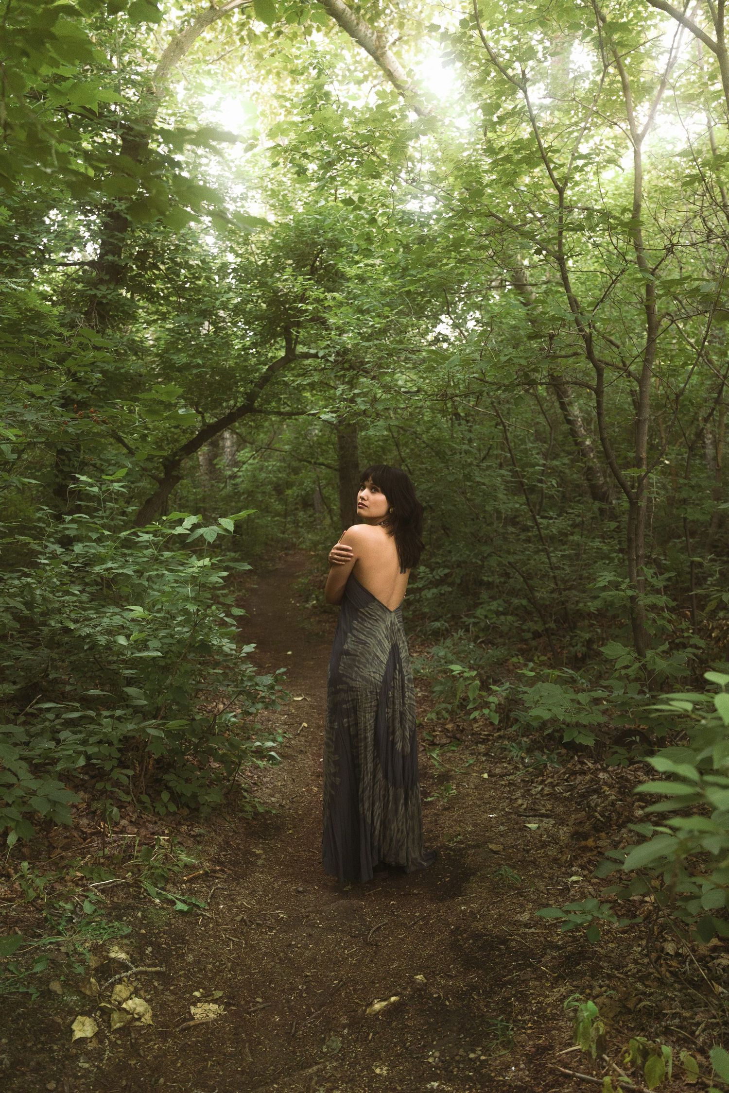 women embracing herself in forest