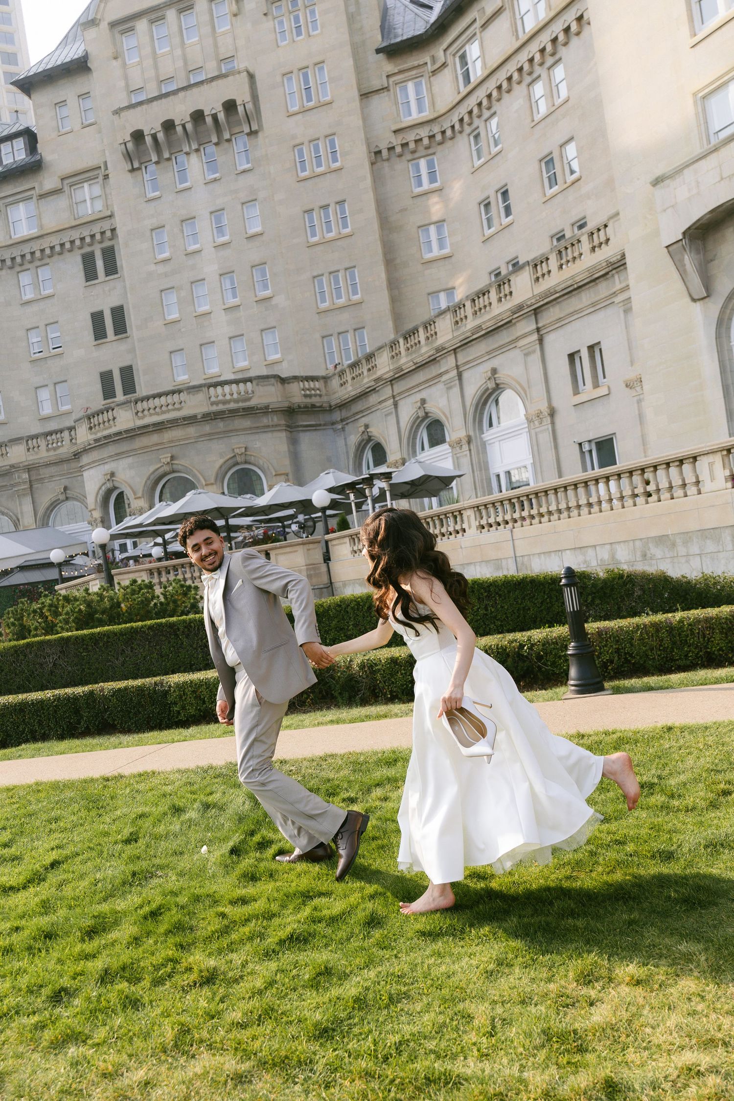 Engagement couple running in field at the fairmont in edmonton