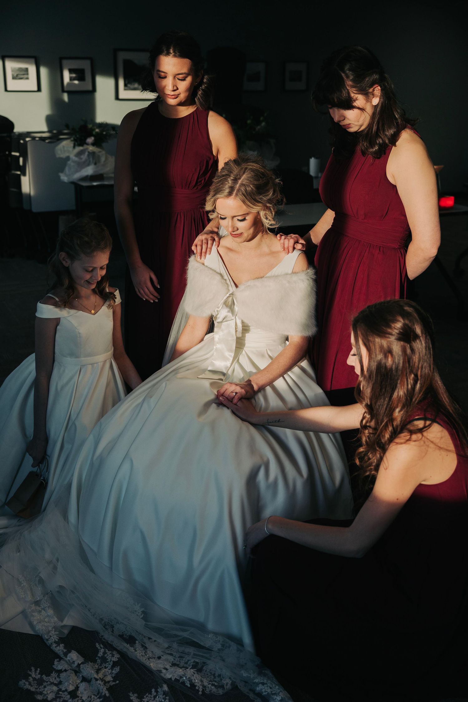 bride with bridesmaids during prayer before wedding ceremony