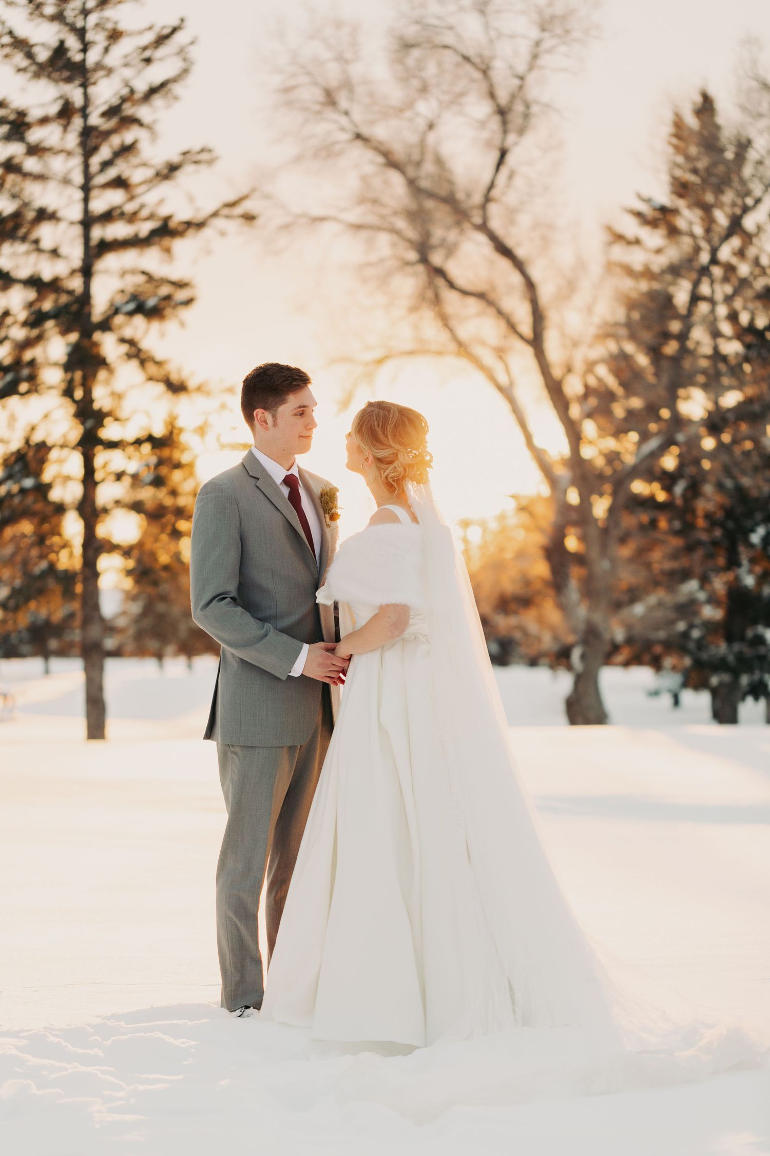 winter wedding portrait of wedding couple during sunset