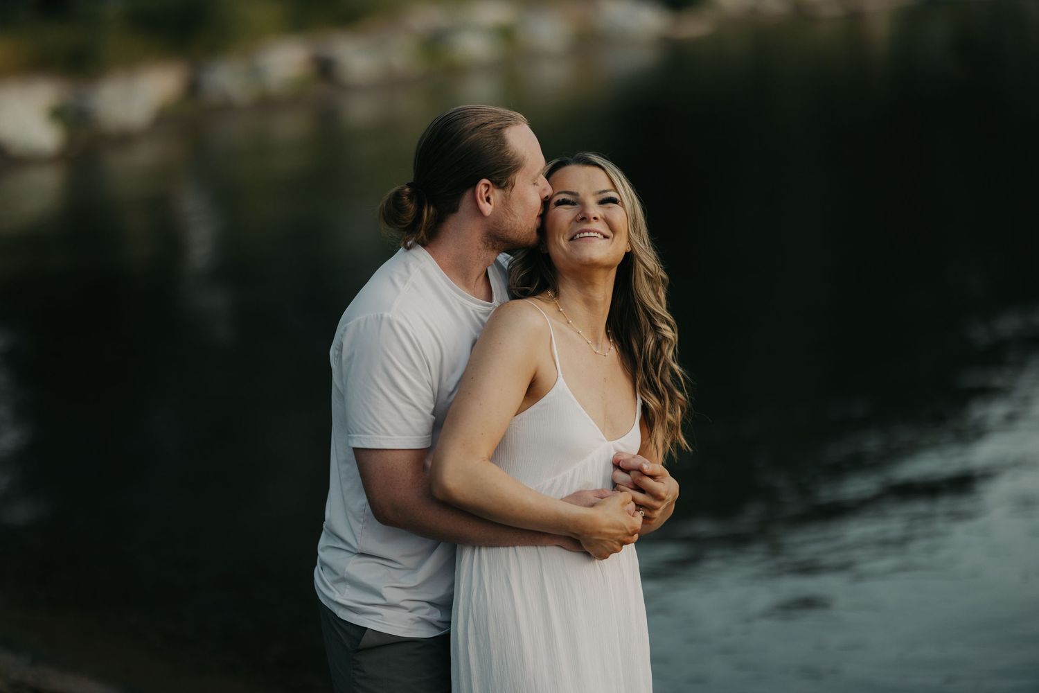 couple hugging with lake in the back in Kelowna