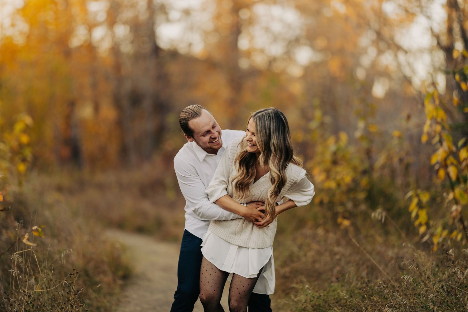 engagement couple having fun in fall photoshoot
