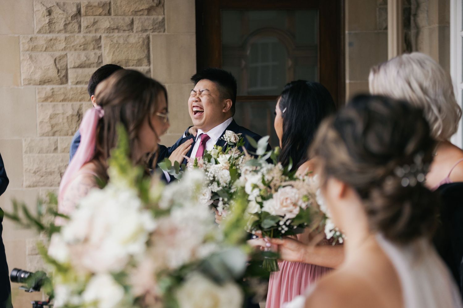 laughter from groom during candid moment of wedding