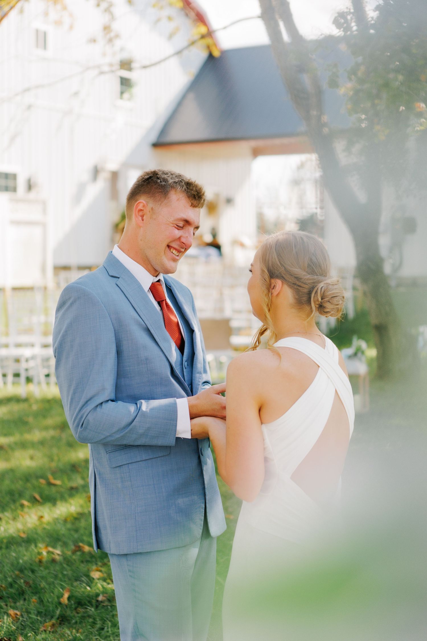 Couple sharing joyful moment in outdoor garden setting.