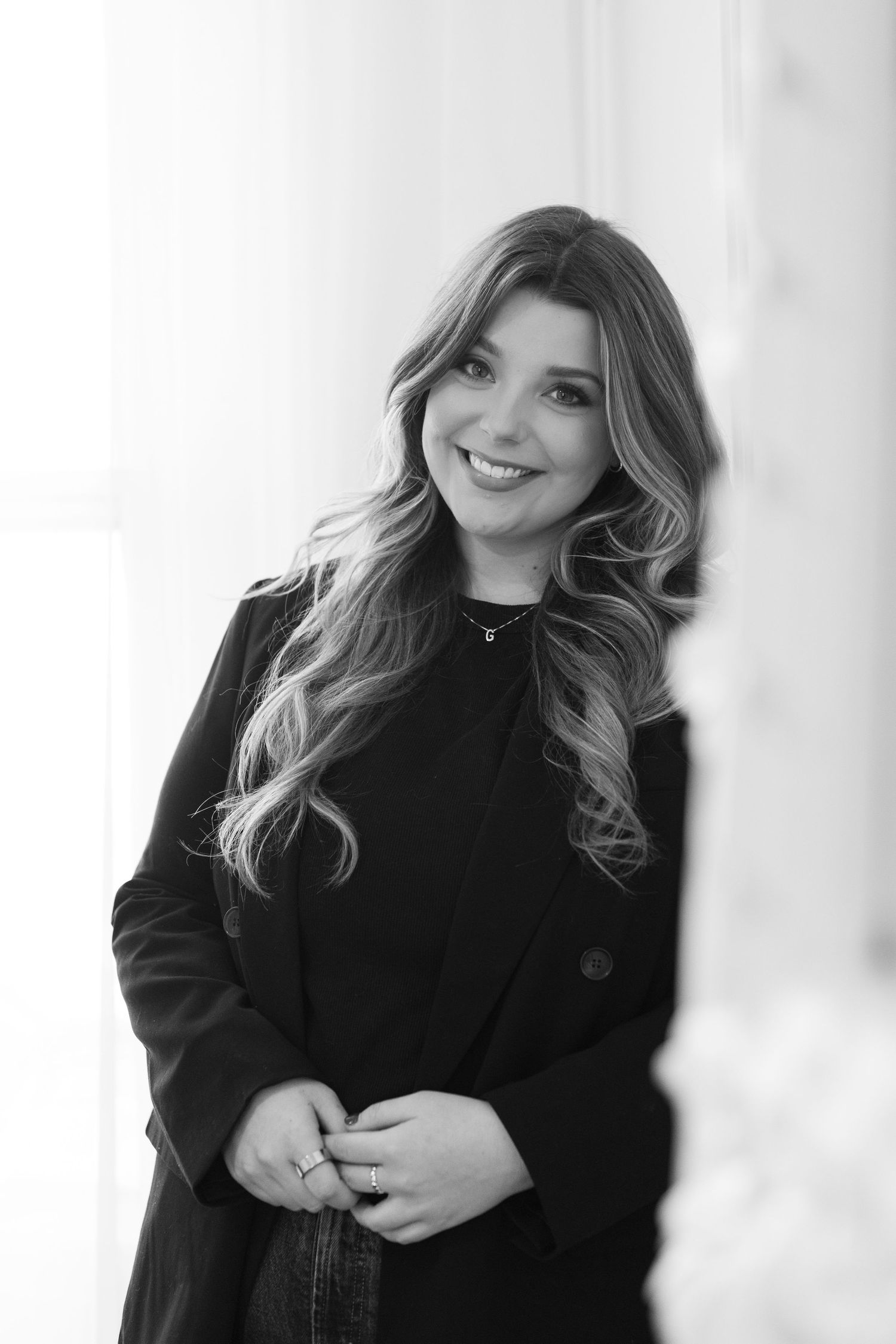 Black and white professional headshots with natural lighting and white backdrop.