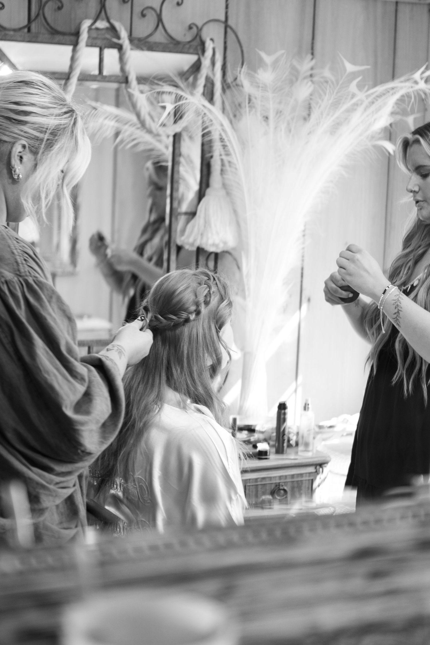 Black and white photo showing preparation activities with soft lighting and ethereal effects.