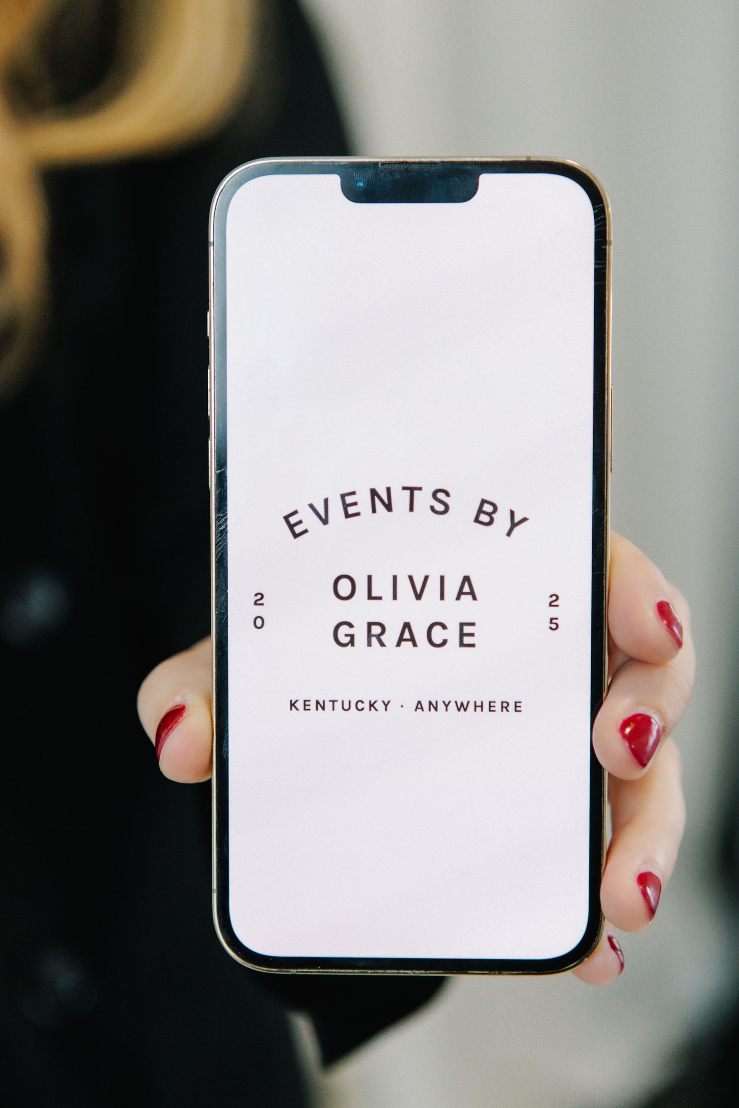 Business cards displaying 'Events By' text with red nail polish visible.