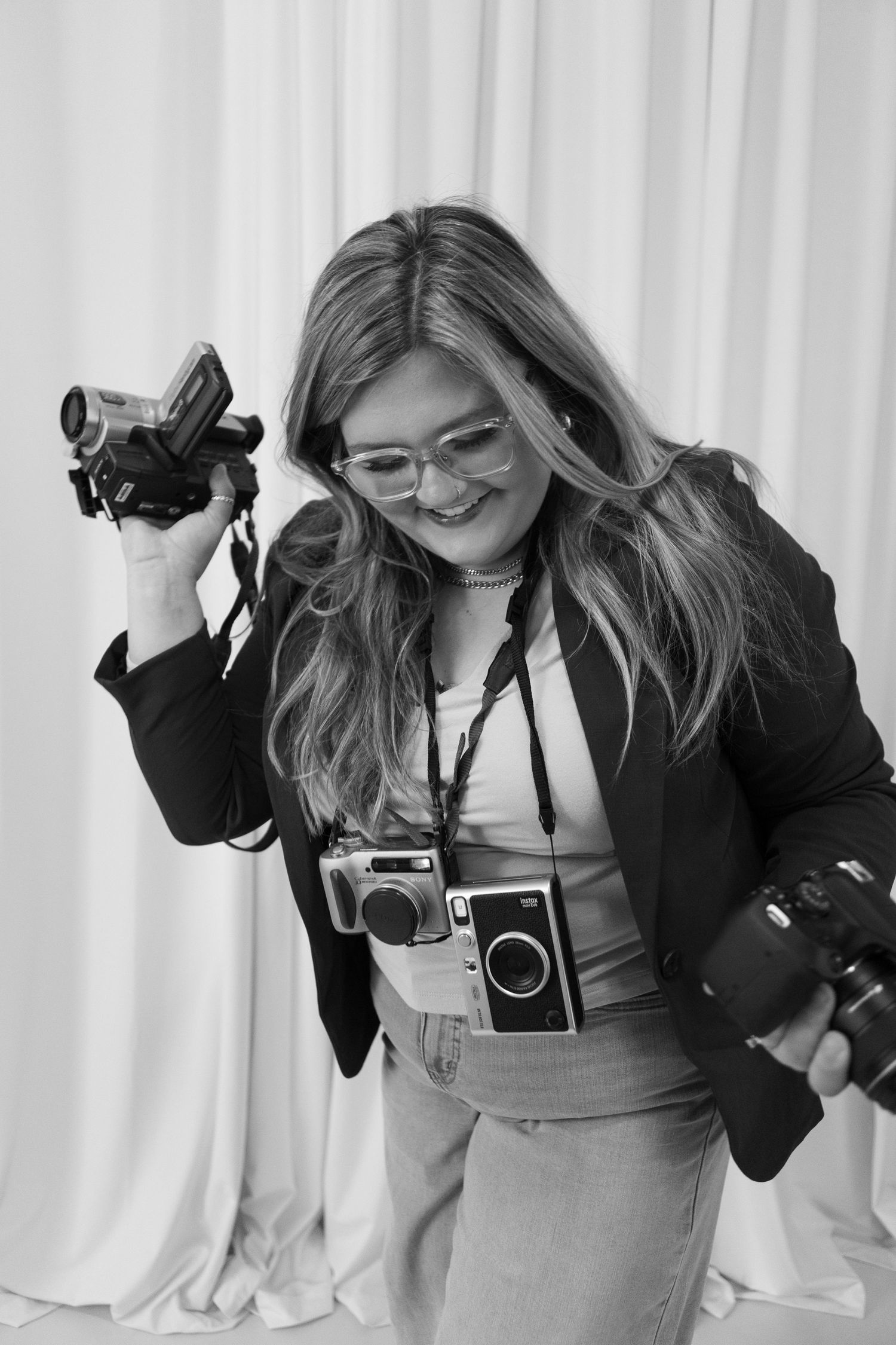 Black and white series of expressive poses with various camera equipment.