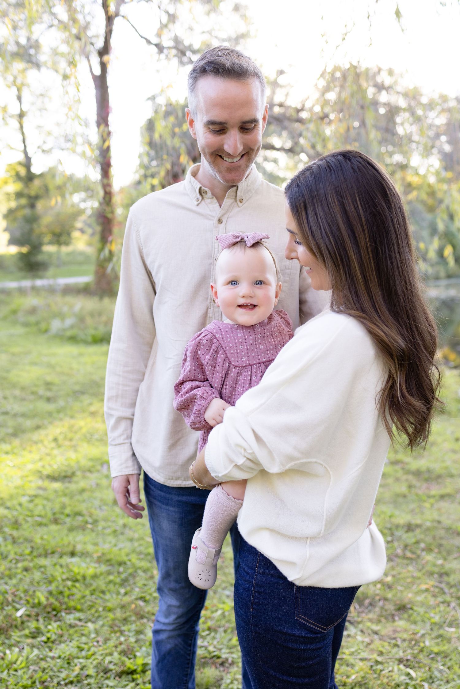 Sweet family interactions captured in a park during fall with natural lighting.
