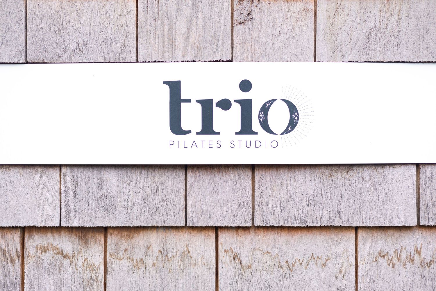 Modern pilates studio with clean white walls and minimalist design elements.