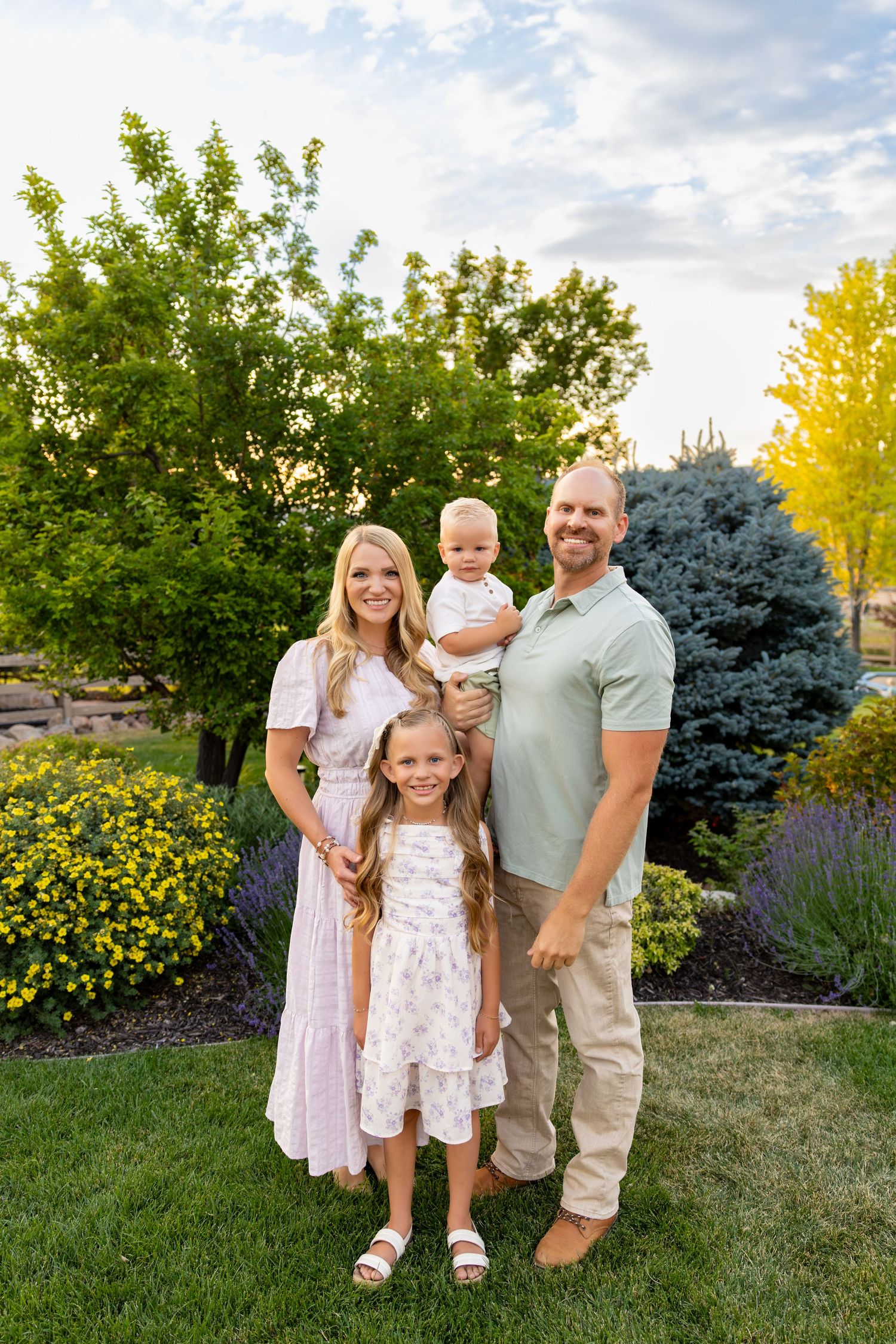 A small family of 4 smiling at the camera during their Extended Family Photos.