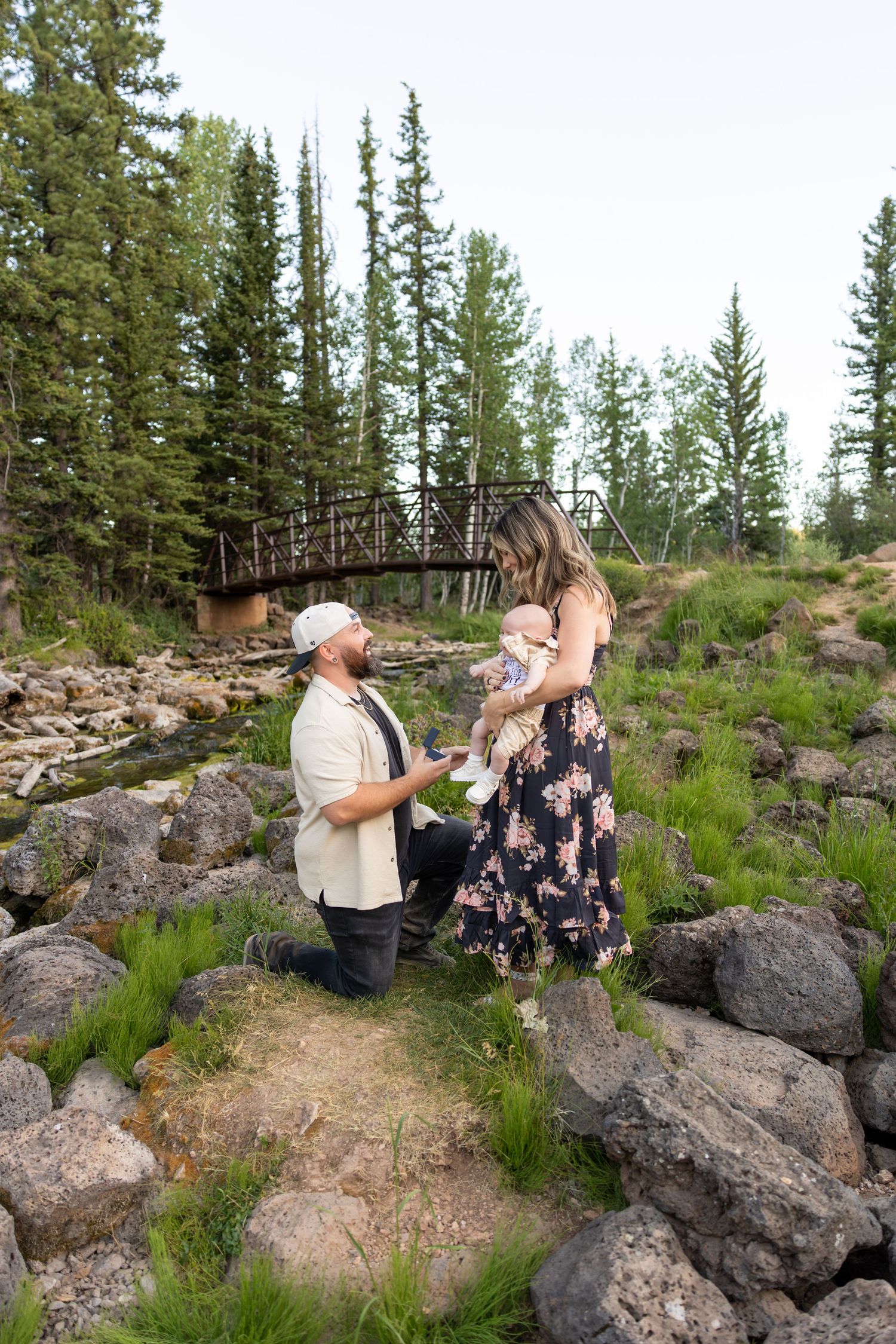 A girlfriend being surprised by her boyfriend proposing. They have their 3 month old with them during their surprise Proposal in Duck Creek.