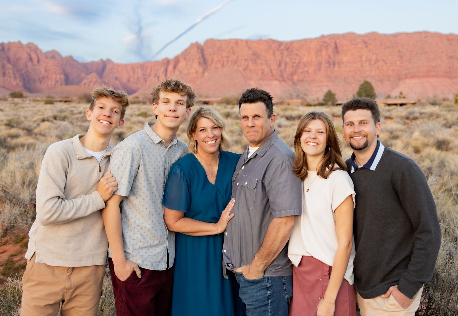 A family of 6 grinning at the camera during a Family Photoshoot near Tuachan in Southern Utah.