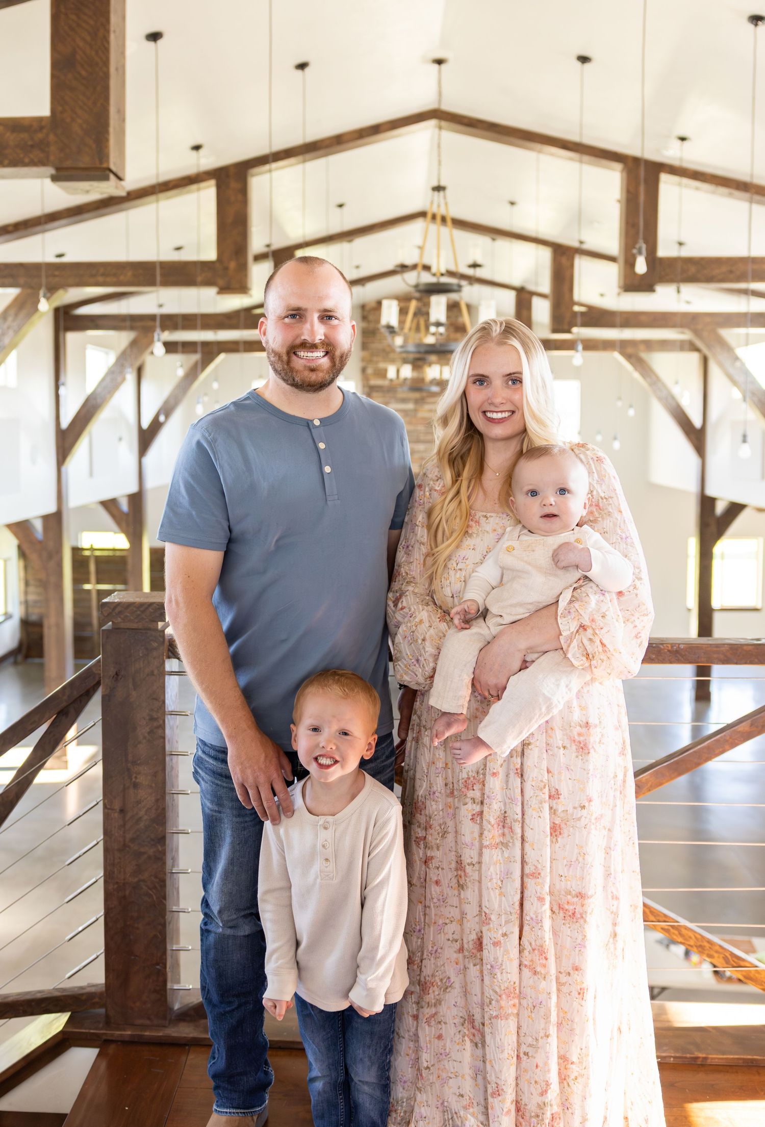 A small family is standing together staring at the camera.