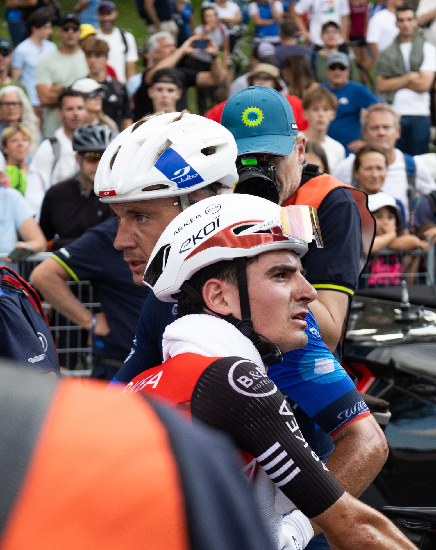 Group of cyclists gathered at the starting line of a professional race.