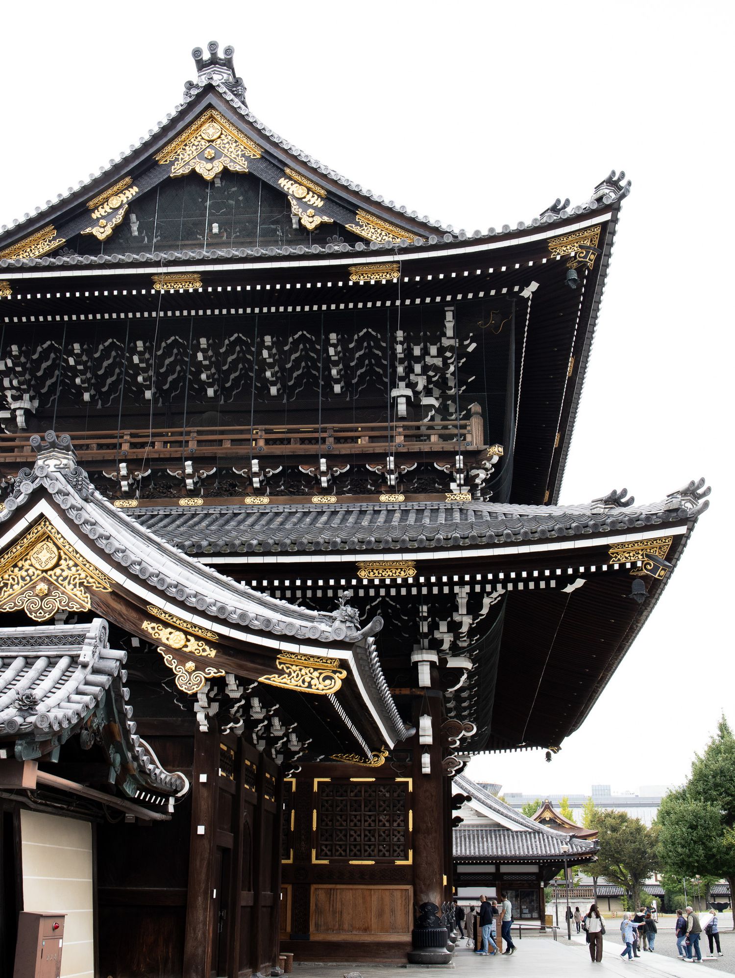 Traditional Japanese temple architecture with ornate black and gold rooflines.