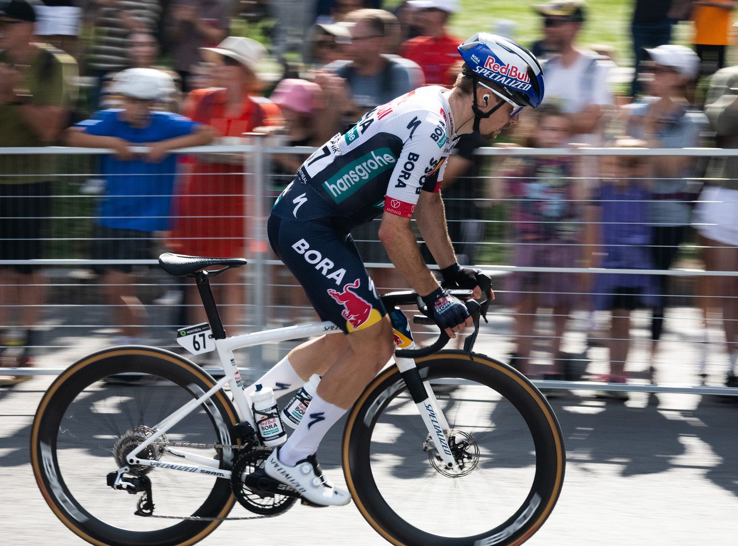 Cyclists racing on aerodynamic bikes during a professional road cycling competition.