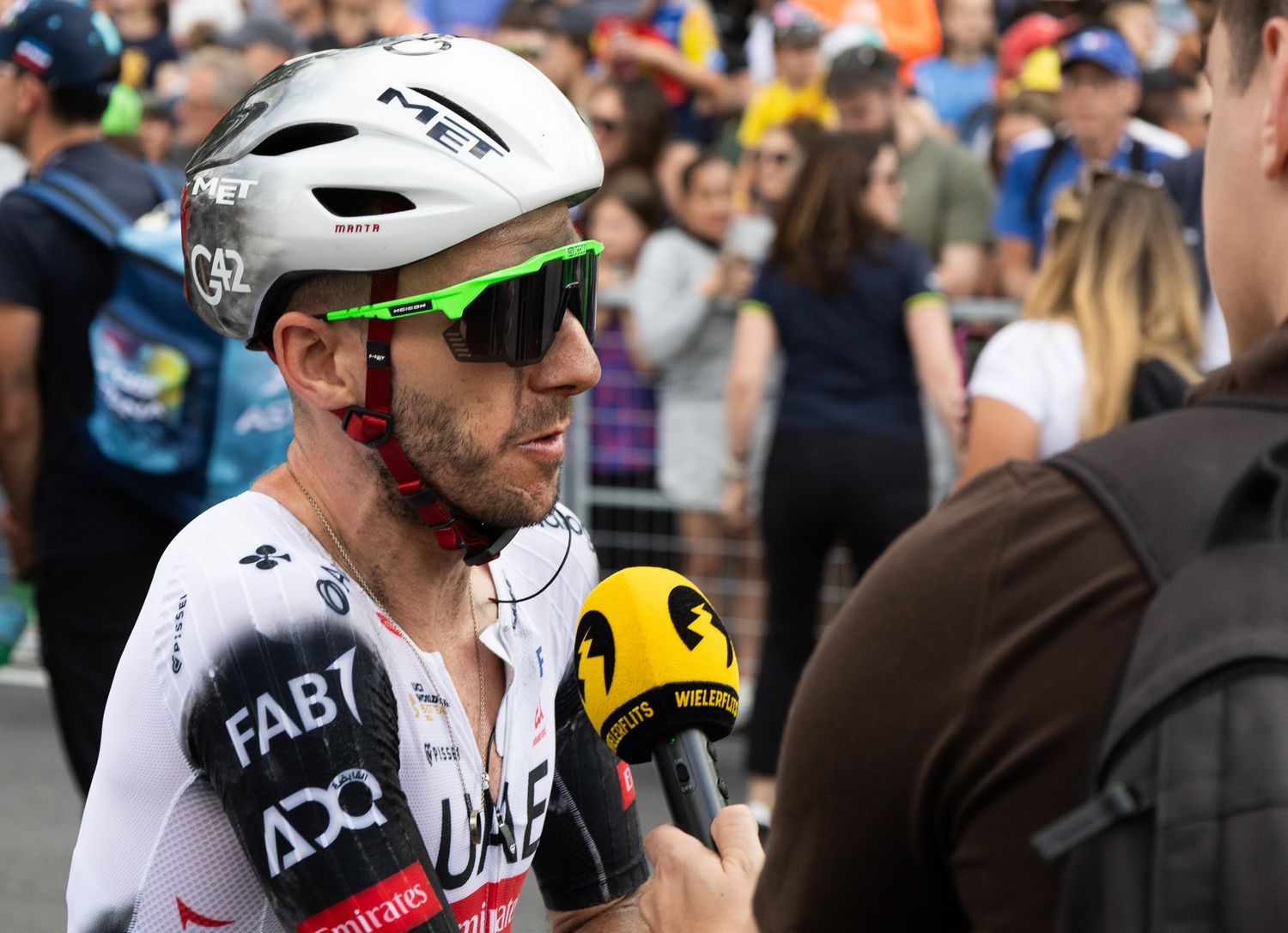 Close-up of cycling helmets and gear during a professional race event.