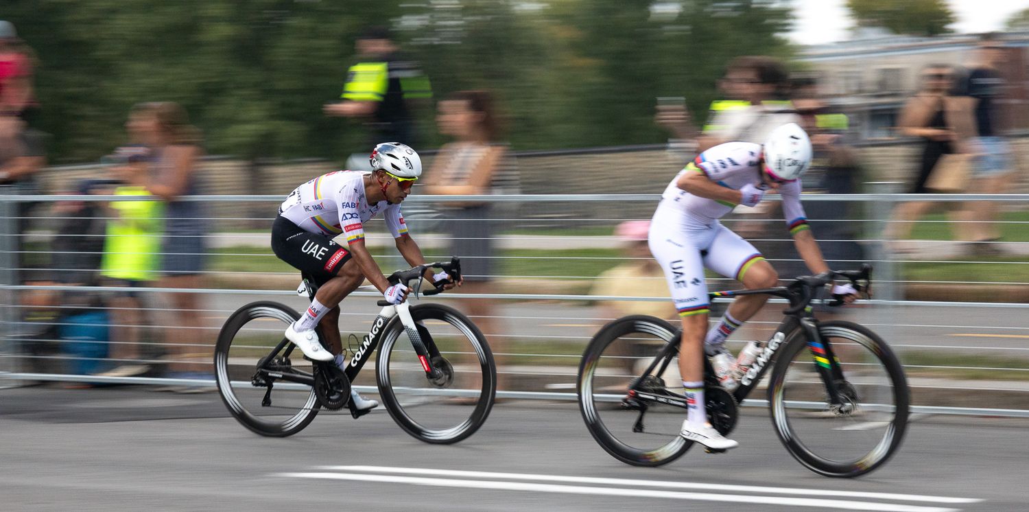 Cyclists competing in a road race with spectators lining the course.