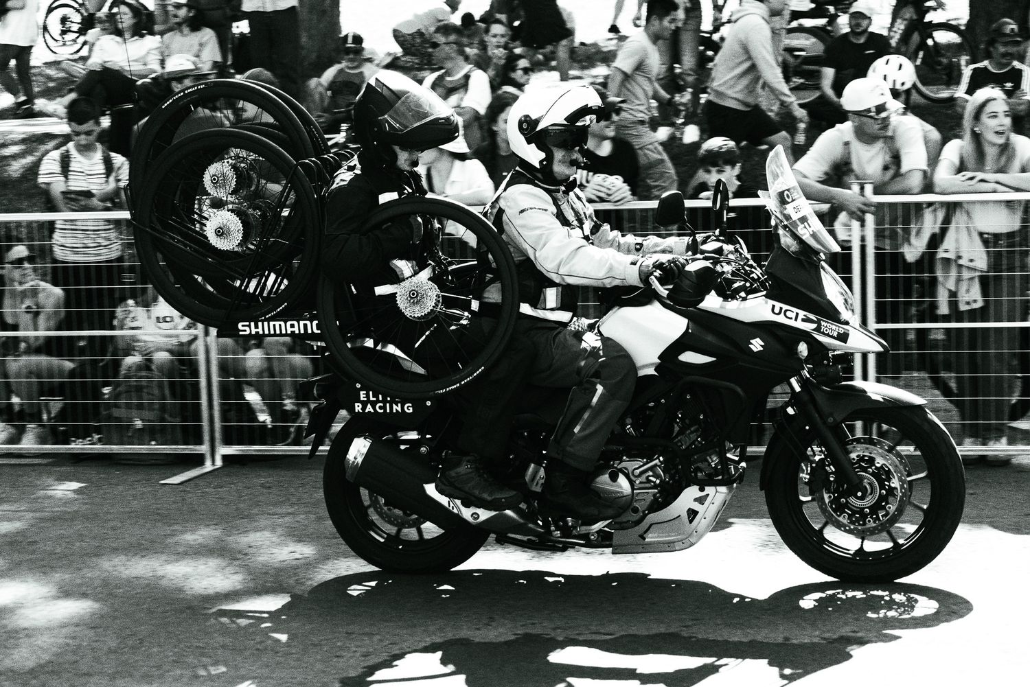 Motorcycle racers leaning into sharp turns during a high-speed race competition.