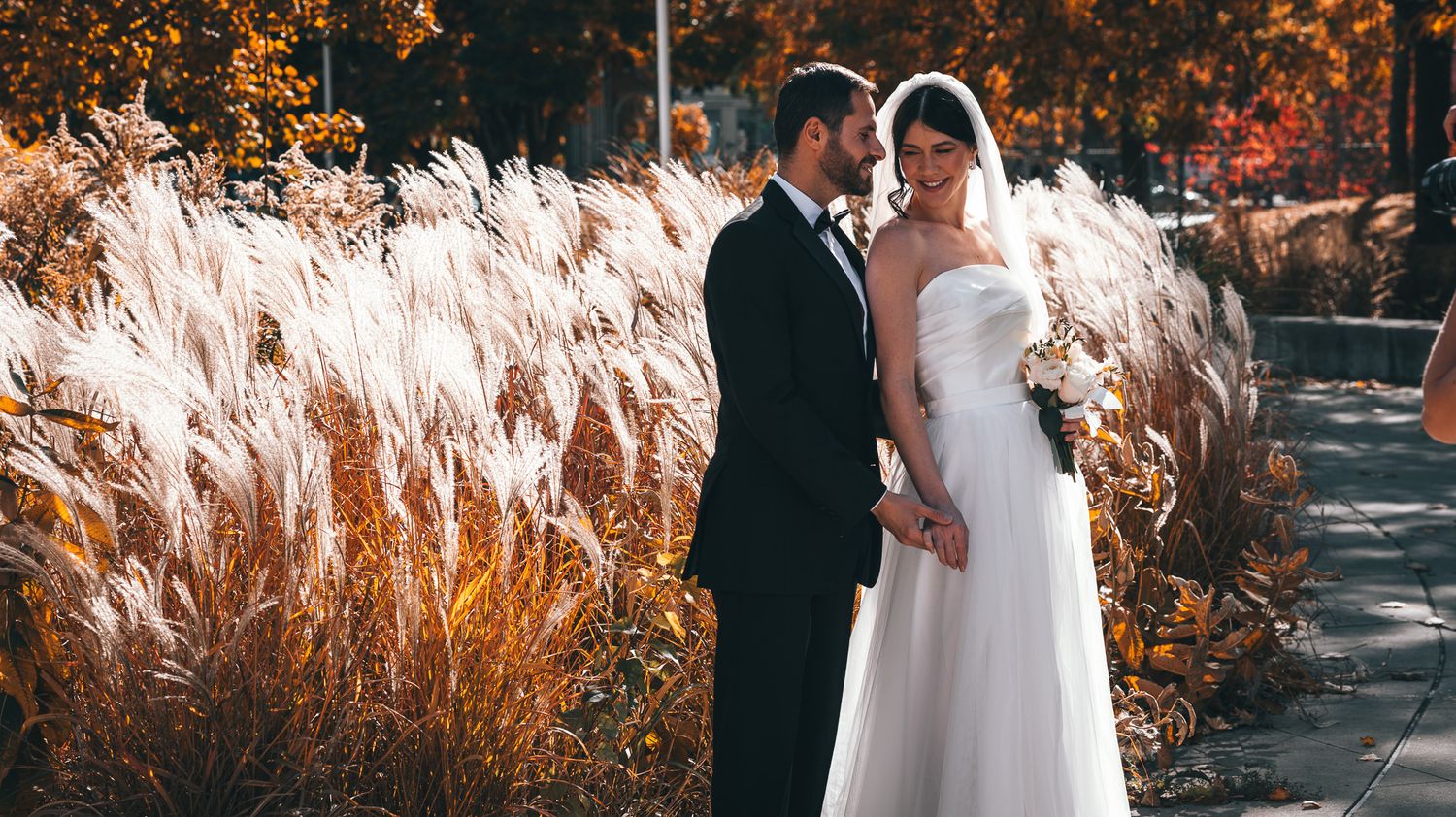 Outdoor autumn wedding ceremony setup with decorative floral arrangements.