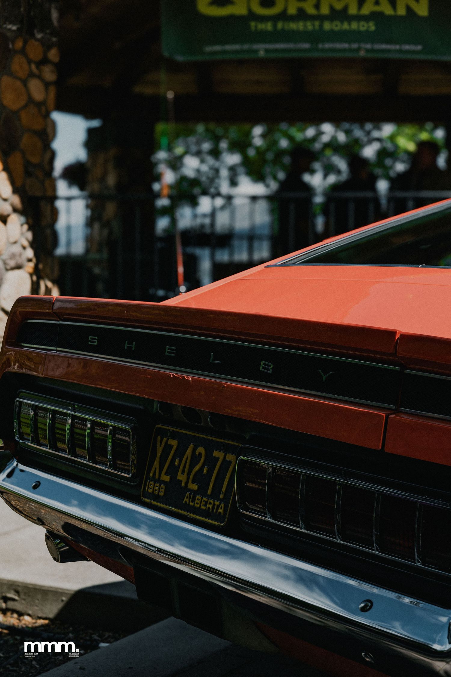 Rear view of orange Shelby classic car with Alberta license plate XZ-4277.