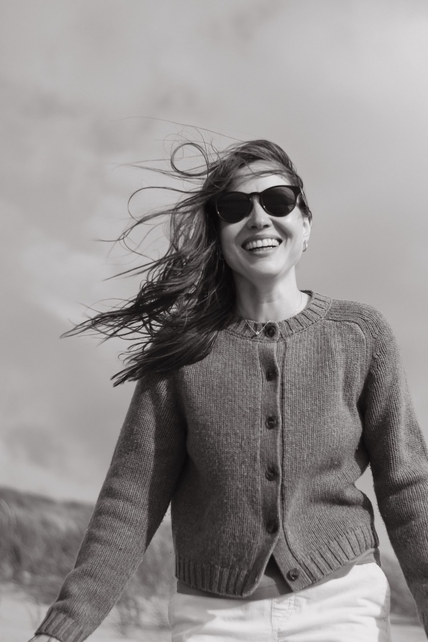 Black and white outdoor portrait of a woman wearing sunglasses